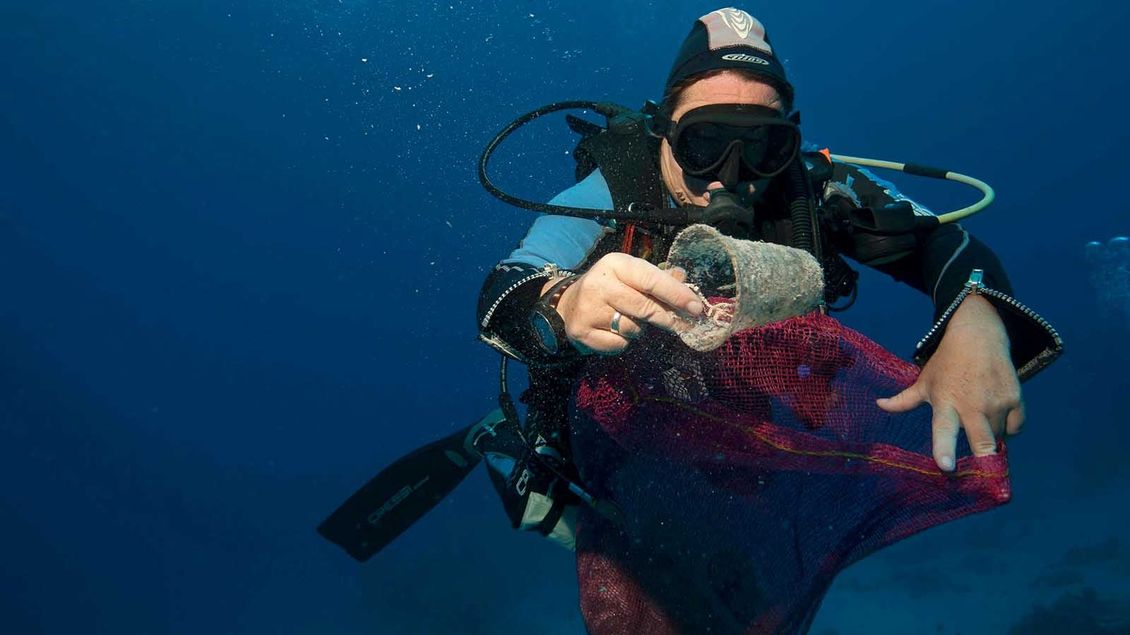 In this June 8, 2018 photo, divers collect plastic and other debris during a cleanup organized by Camel Dive Club, at a dive site off the coast of the Red Sea resort of Sharm el Sheik, in Southern Sinai, Egypt.An Egyptian official says his Red Sea province will impose a ban on disposable plastics, prohibiting everything from single use straws to plastic bags in an effort to fight plastic pollution. Ahmed Abdallah, governor of Hurghada province, said late on Tuesday, April, 2, 2019, that the ban will go into effect from June. (AP Photo/Thomas Hartwell)