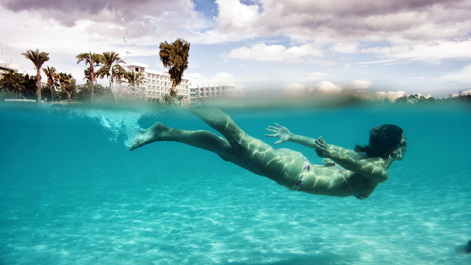 Young adult women wearing swimsuit in blue sea.