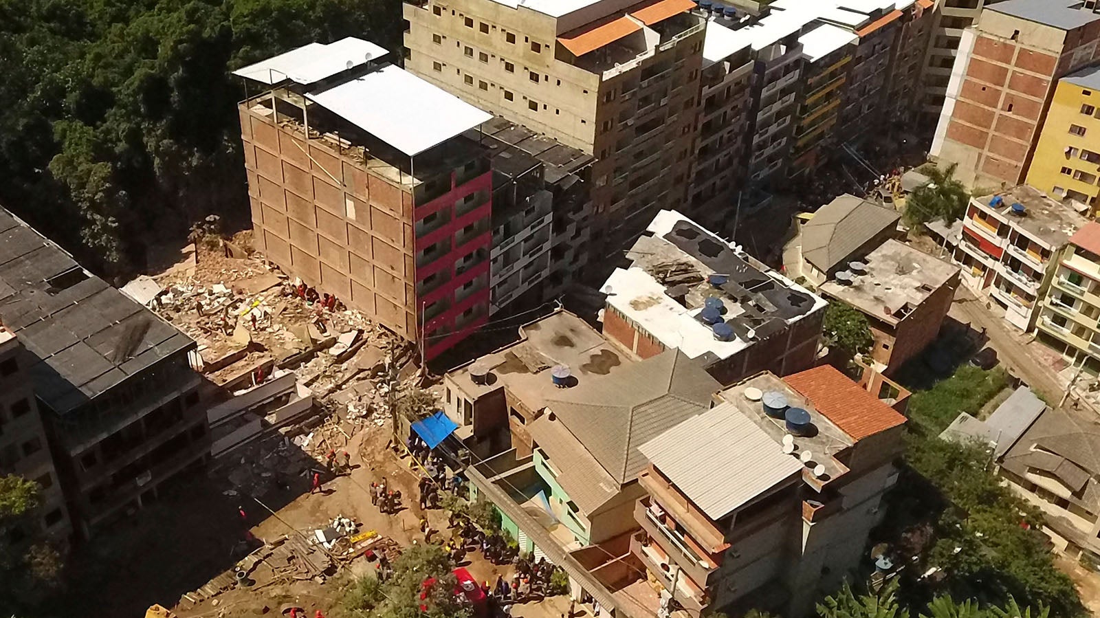 An aerial view of the site where two buildings collapsed in the Muzema neighborhood, Rio de Janeiro, Brazil, Friday, April 12, 2019. The collapse came in a western part of the city that was particularly hard hit by heavy rains this week that caused massive flooding. (AP Photo/Renato Spyrro)