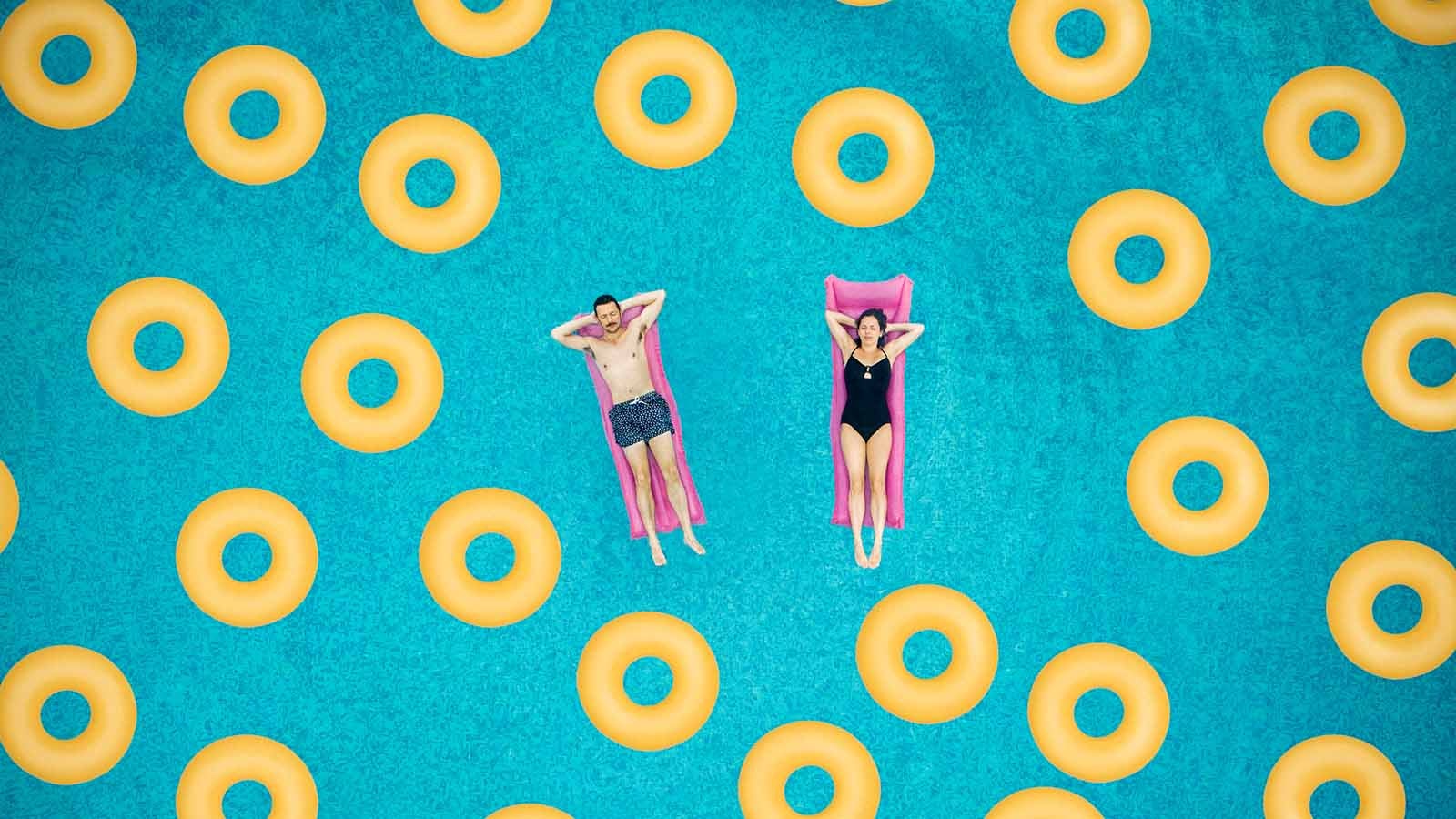 Couple on ring in swimming pool