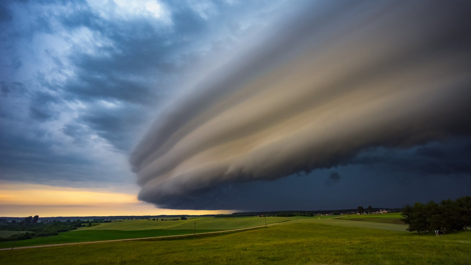 Angry supercell storm influenced by Climate change. Dangerous storm supercell shelf cloud with layers. High quality photo