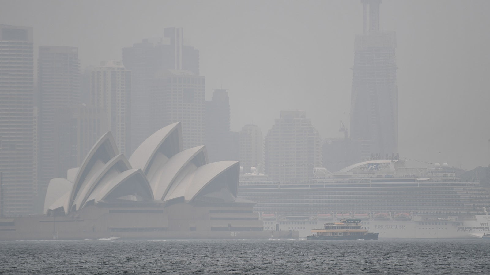 The Sydney Opera House is seen through smoke haze from bushfires in Sydney, Wednesday, January 8, 2020. (AAP Image/Steven Saphore) NO ARCHIVING