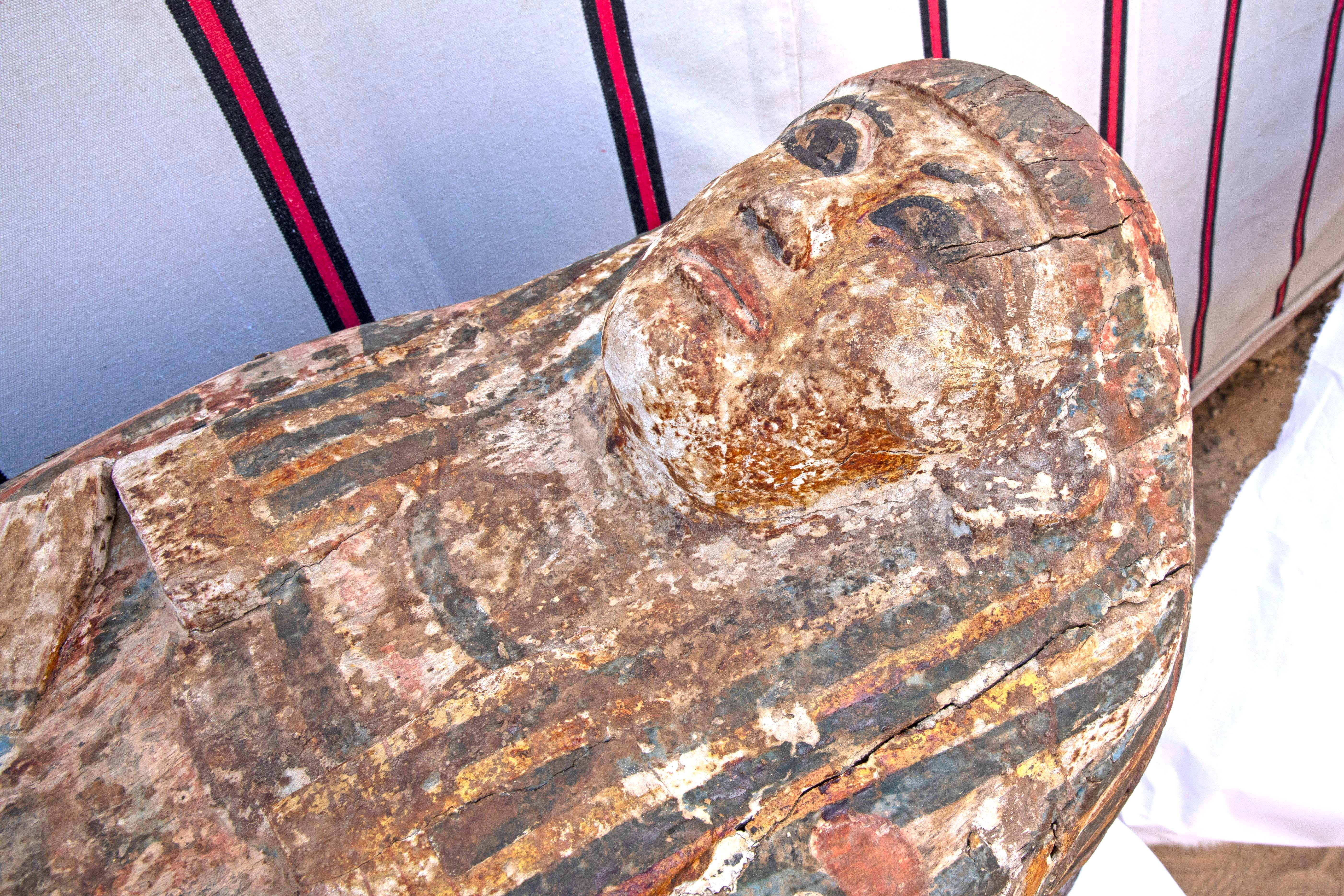 An ancient coffin is on display that Egyptian archaeologist Zahi Hawass and his team unearthed in a vast necropolis filled with burial shafts, coffins and mummies dating back to the New Kingdom 3000 BC, Monday, Jan. 17, 2021, in Saqqara, south of Cairo, Egypt. (AP Photo/Nariman El-Mofty)