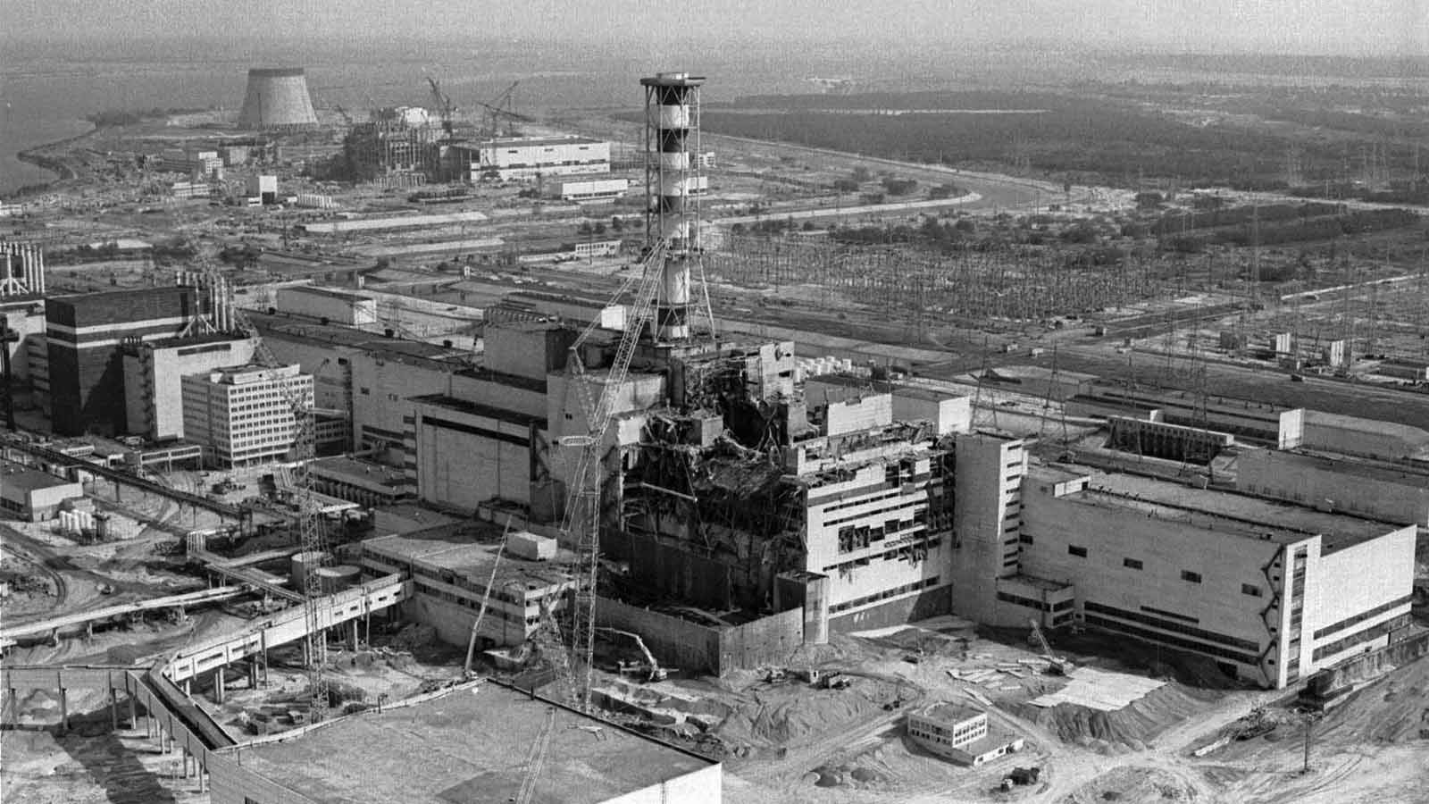 FILE - This April 26, 1986 file photo shows an aerial view of the Ukrainian Chernobyl nuclear plant, with damage from an explosion and fire in reactor four on that sent large amounts of radioactive material into the atmosphere. The vast and empty Chernobyl Exclusion Zone around the site of the world&rsquo;s worst nuclear accident is a baleful monument to human mistakes. Yet 35 years after a power plant reactor exploded, Ukrainians also look to it for inspiration, solace and income. (AP Photo/ Volodymyr Repik)