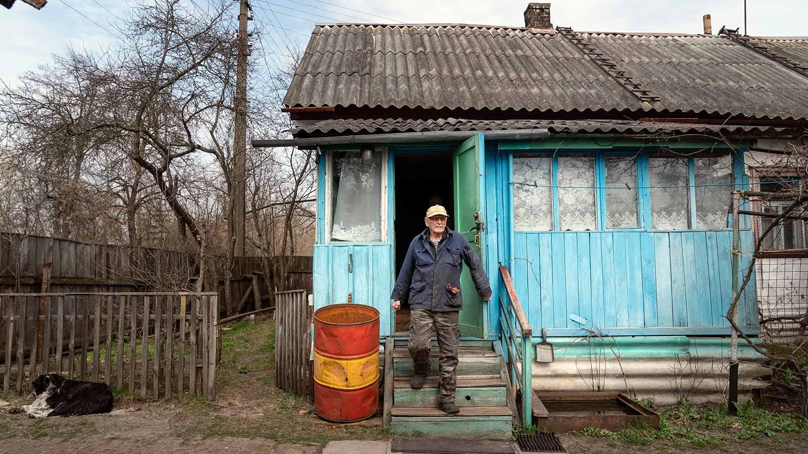 Yevgeny Markevich, a 85-year-old former teacher, leaves his house at the Chernobyl exclusion zone, Ukraine, Wednesday, April 14, 2021. Markevich said "It's a great happiness to live at home, but it's sad that it's not as it used to be." Today, he grows potatoes and cucumbers on his garden plot, which he takes for tests "in order to partially protect myself." The vast and empty Chernobyl Exclusion Zone around the site of the world&rsquo;s worst nuclear accident is a baleful monument to human mistakes. Yet 35 years after a power plant reactor exploded, Ukrainians also look to it for inspiration, solace and income. (AP Photo/Evgeniy Maloletka)