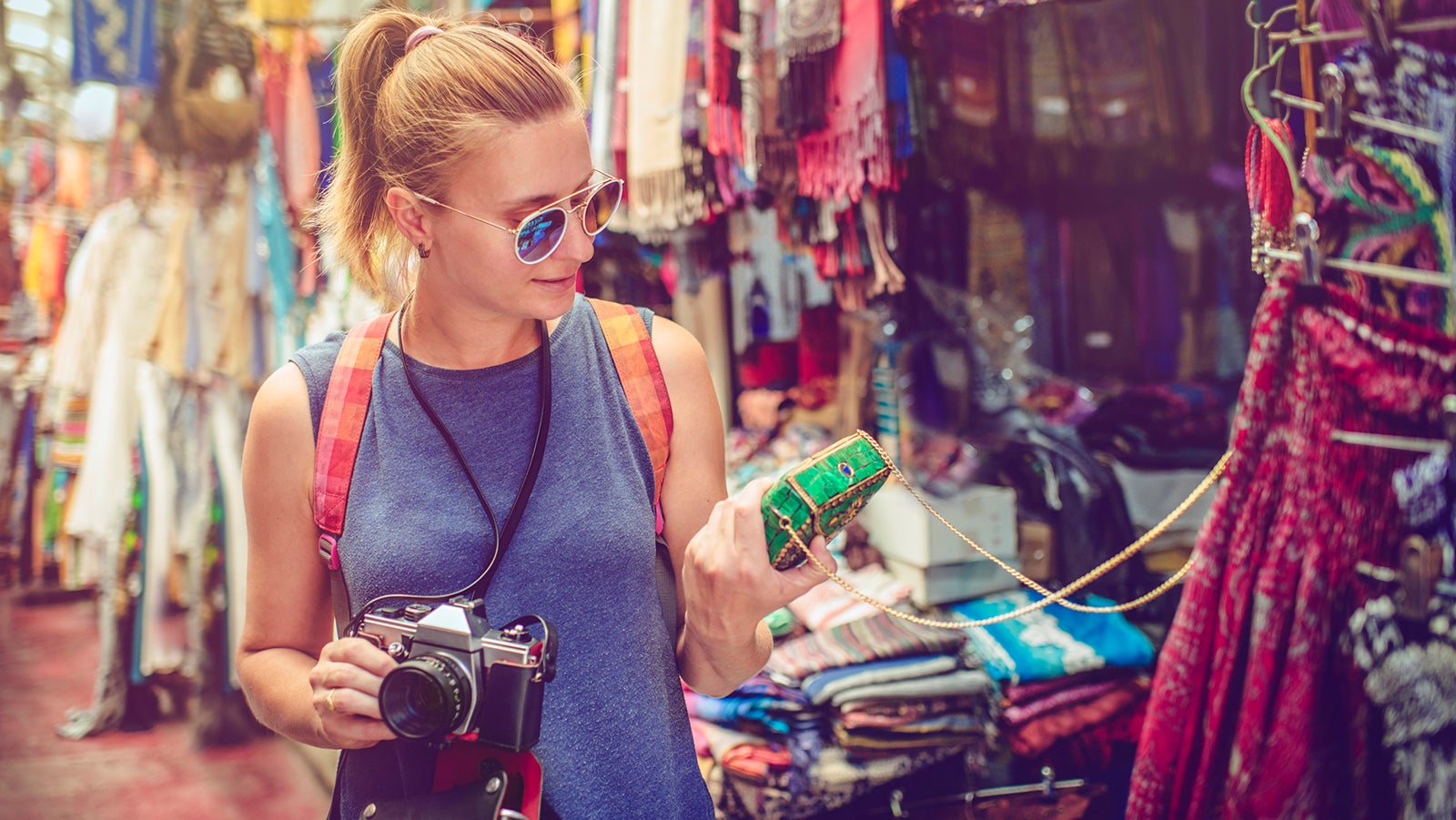 Young woman and man walking through local market in Israel