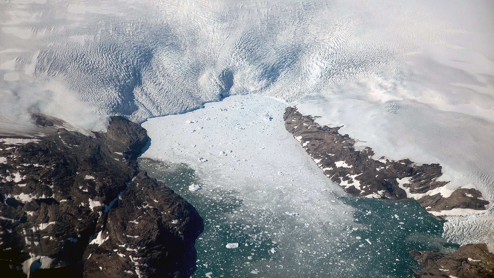ARCHIV - 03.08.2017, Arktis, ---: Eisberge brechen von einem Gletscher in einen Fjord in Gr&ouml;nland. Schmelzen die Gletscher und Eisfl&auml;chen etwa in Gr&ouml;nland, steigen die Meeresspiegel. (zu dpa "Studie: Erderw&auml;rmung in Arktis fast viermal schneller als weltweit") Foto: David Goldman/AP/dpa +++ dpa-Bildfunk +++