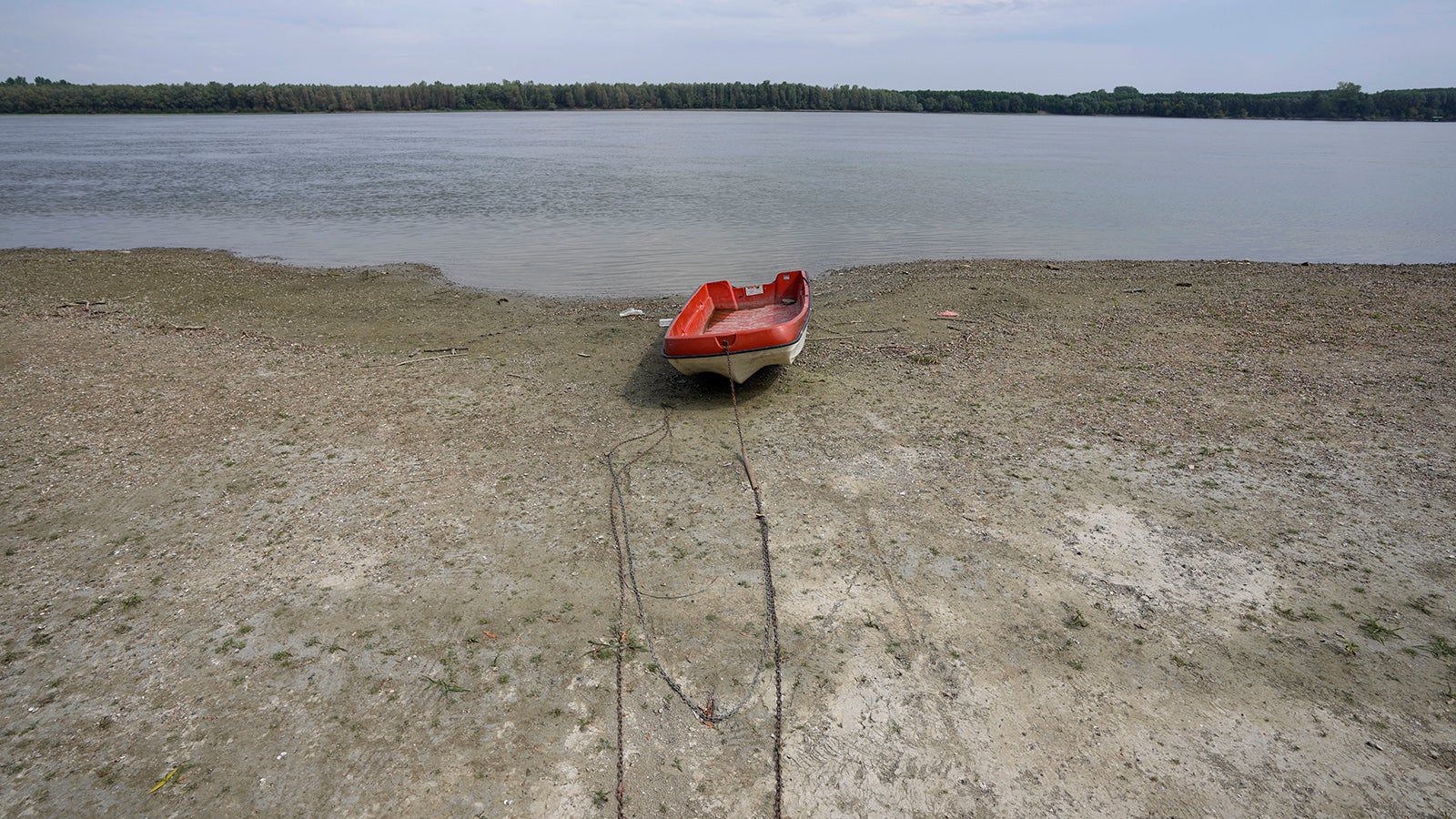 FILE - A boat laying on a dry bank of river Danube after a long time of drought near the village of Cortanovci, 50 kilometers north-west of Belgrade, Serbia, Tuesday, Aug. 9, 2022. (AP Photo/Darko Vojinovic, File)