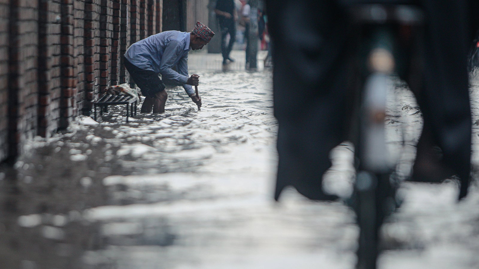 June 8, 2022, Kathmandu, Bagmati, Nepal: A man tries to open a drainage system for the smooth flow of water while the road is flooded with rain water at Anamnagar,Kathmandu on Wednesday..The roads in the valley suffers from frequent flash floods as a result of poor drainage system during the monsoon season. Kathmandu Nepal - ZUMAm204 20220608_zip_m204_005 Copyright: xAmitxMachamasix