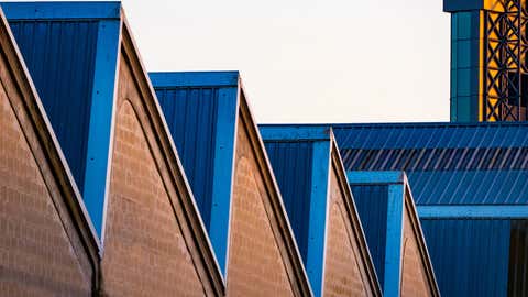 Industrial building with bluish roofs and triangular geometric shapes