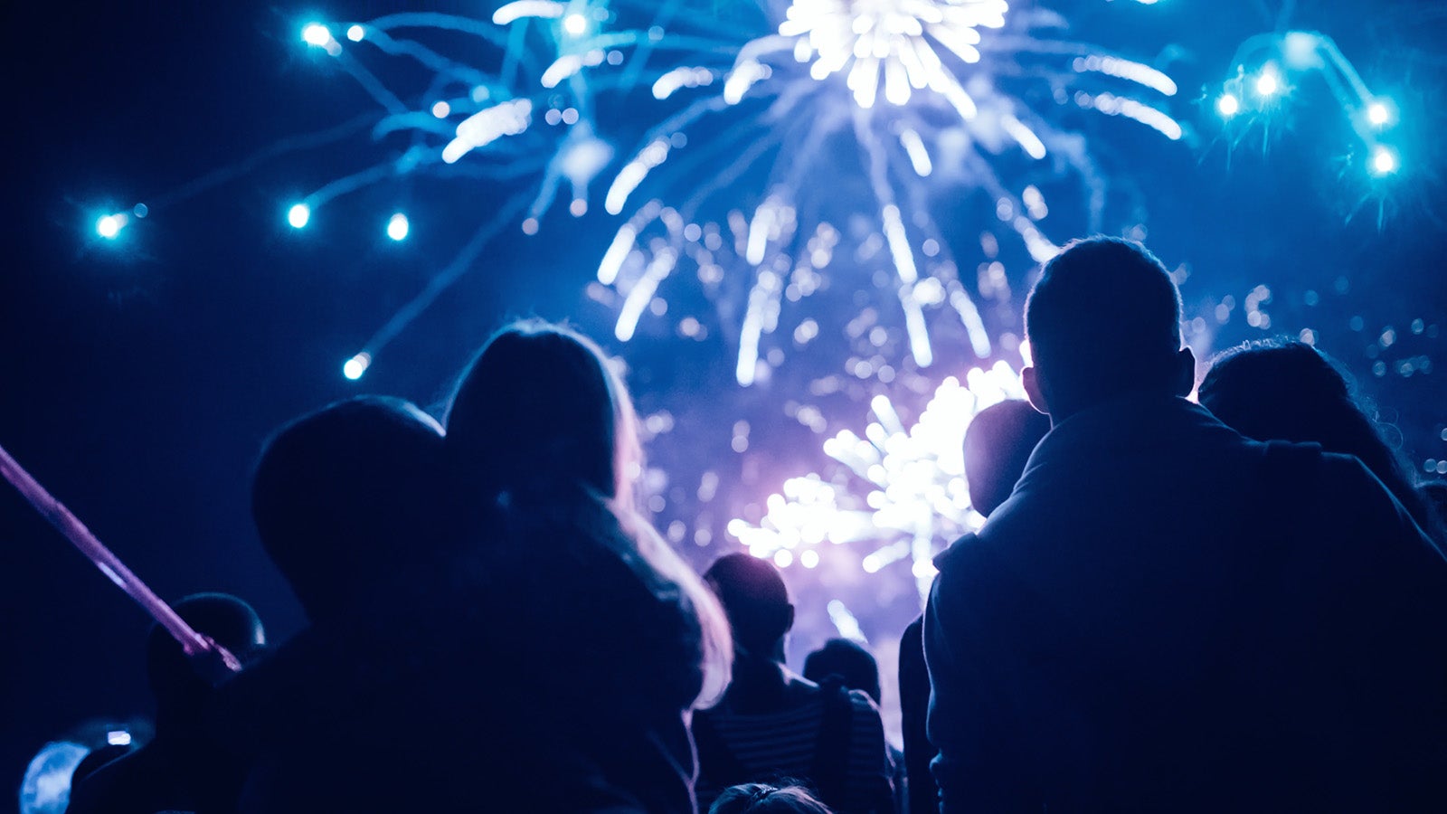 Crowd watching fireworks and celebrating at night