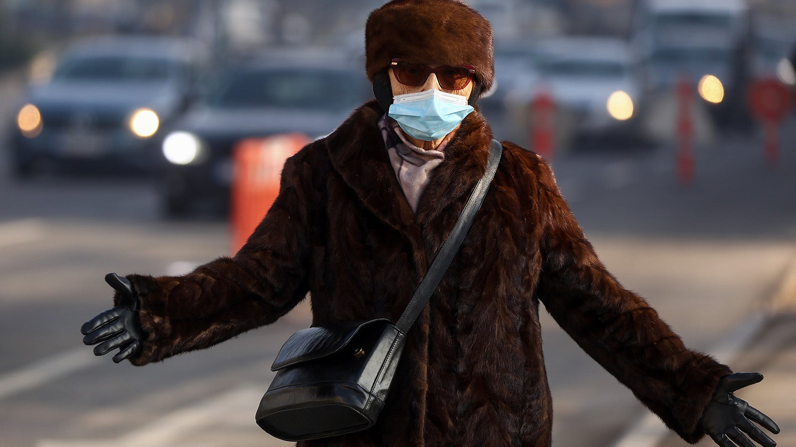 A woman wears a face mask shrouded by pollution haze as smog covers Sarajevo, Bosnia, Thursday, Dec. 19, 2024. (AP Photo/Armin Durgut)