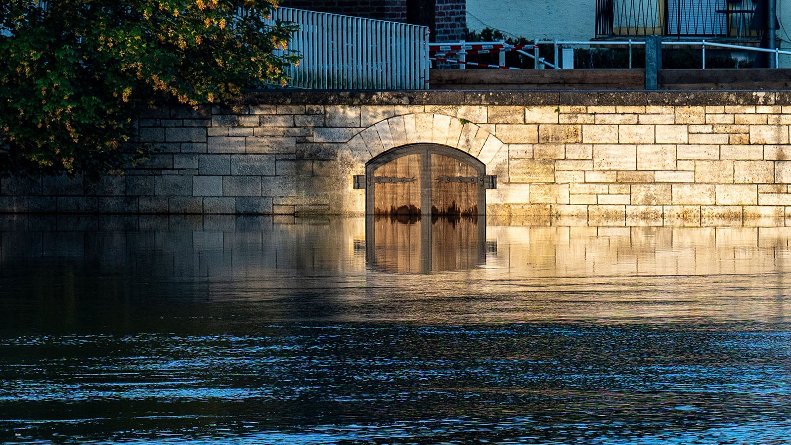 dpatopbilder - 05.06.2024, Bayern, Straubing: Ein Tor ist vom Hochwasser der Donau umgeben. In einigen Hochwassergebieten in S&uuml;ddeutschland entsch&auml;rft sich die Lage, an der unteren Donau bleibt sie gespannt. Foto: Armin Weigel/dpa +++ dpa-Bildfunk +++