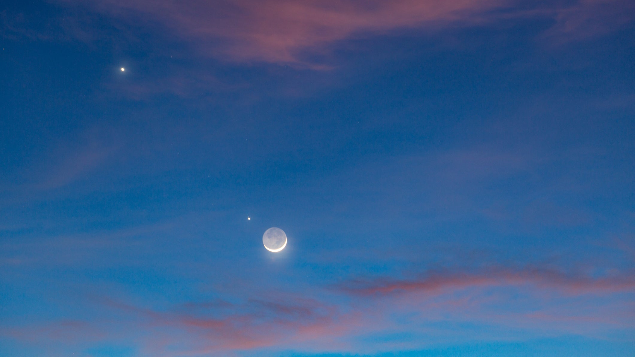 The beautiful twilight sky (Nov 28, 2019) after sunset with the planets conjuction of Moon (with earth shine), Venus and Jupiter.