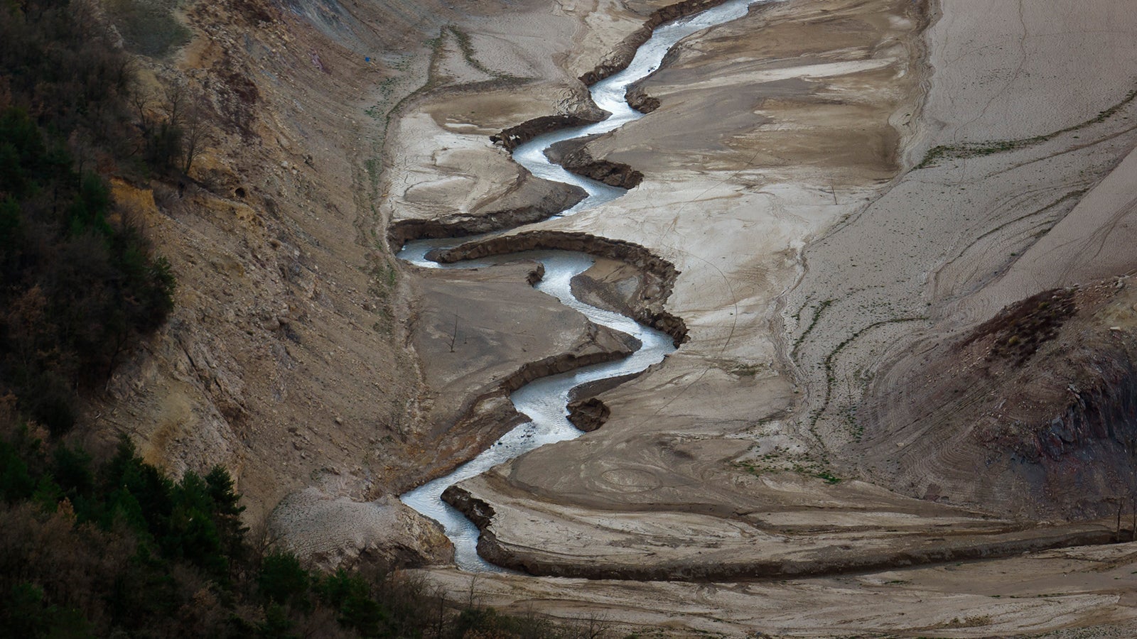 View of La Baells reservoir in Berga, about 112 km (69 miles) north of Barcelona. Spain, Sunday, March 26, 2023. Farmers and parishioners gathered Sunday at the small hermitage of l'Espunyola, a rural village in Catalonia, to attend a mass asking the local virgin Our Lady of the Torrents for rain. All three reservoirs near the village are below a third of their capacity, with la Baells reservoir only a 25% full. They are no exception to reservoirs in the Barcelona region, after a strike of 30 months of very little rain. (AP Photo/Emilio Morenatti)