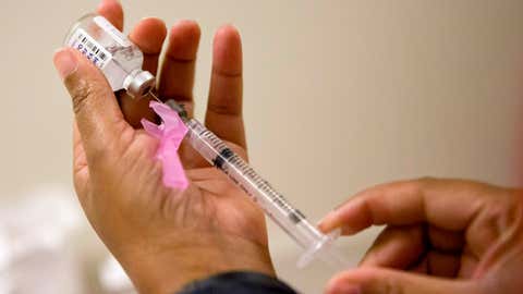 FILE - In this Feb. 7, 2018 file photo, a nurse prepares a flu shot at the Salvation Army in Atlanta.  The flu forecast is cloudy and it’s too soon to know if the U.S. is in for a third miserable season in a row, but health officials said Thursday, Sept. 26, 2019 not to delay vaccination. (AP Photo/David Goldman, File)