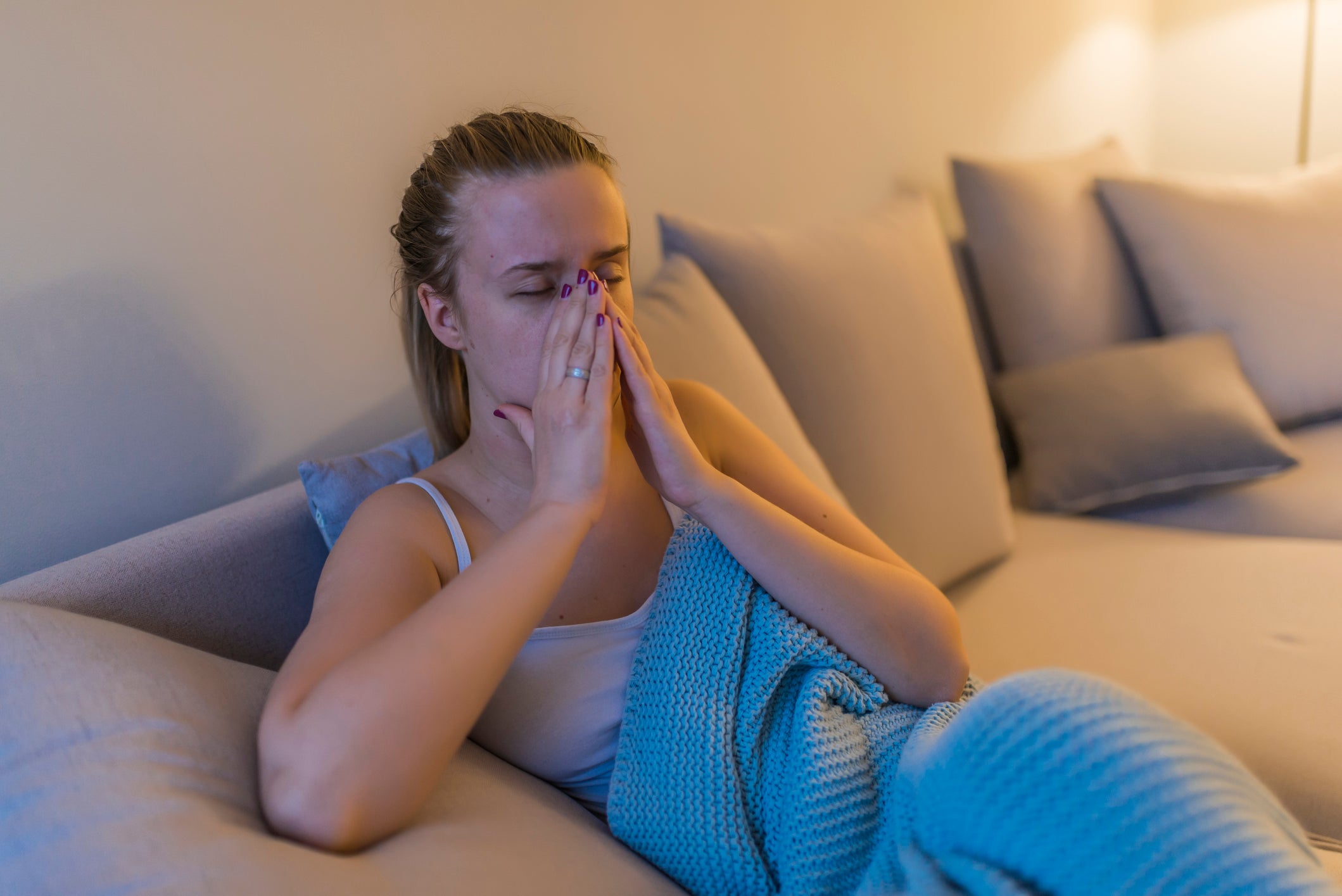 Young woman with headache,sniffle and sinus pain. Sinus ache causing very paintful headache. Unhealthy woman in pain. Young woman with sinus pressure pain