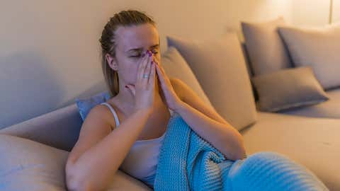 Young woman with headache,sniffle and sinus pain. Sinus ache causing very paintful headache. Unhealthy woman in pain. Young woman with sinus pressure pain