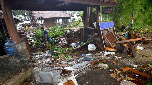 A man walks amid debris from damaged buildings in Carita on Sunday, December 23, 2018, after the area was hit by a tsunami following an eruption of the Anak Krakatoa volcano. (Ronald/AFP/Getty Images)