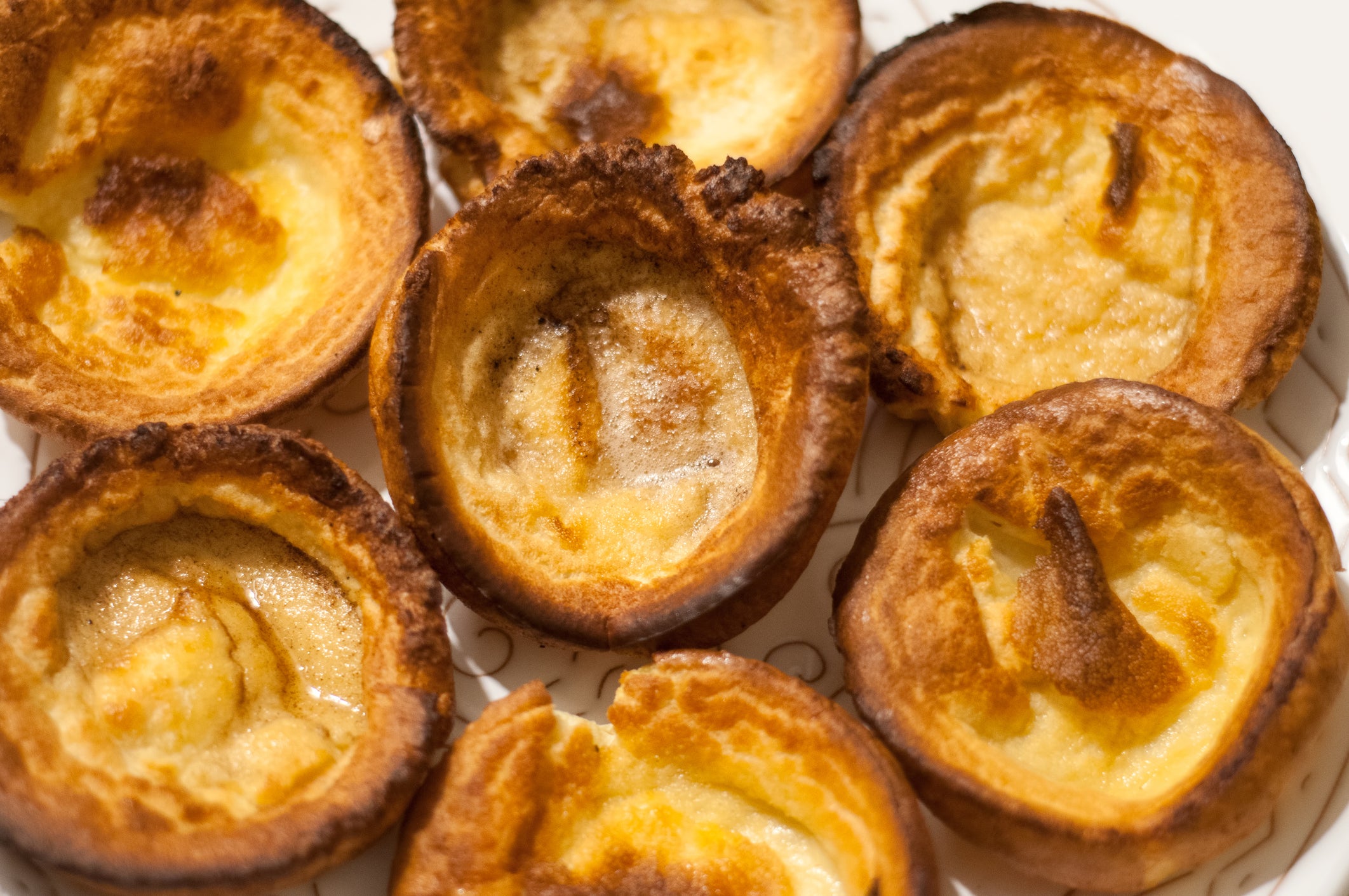 Traditional British Yorkshire Puddings on a white plate in wintertime.
