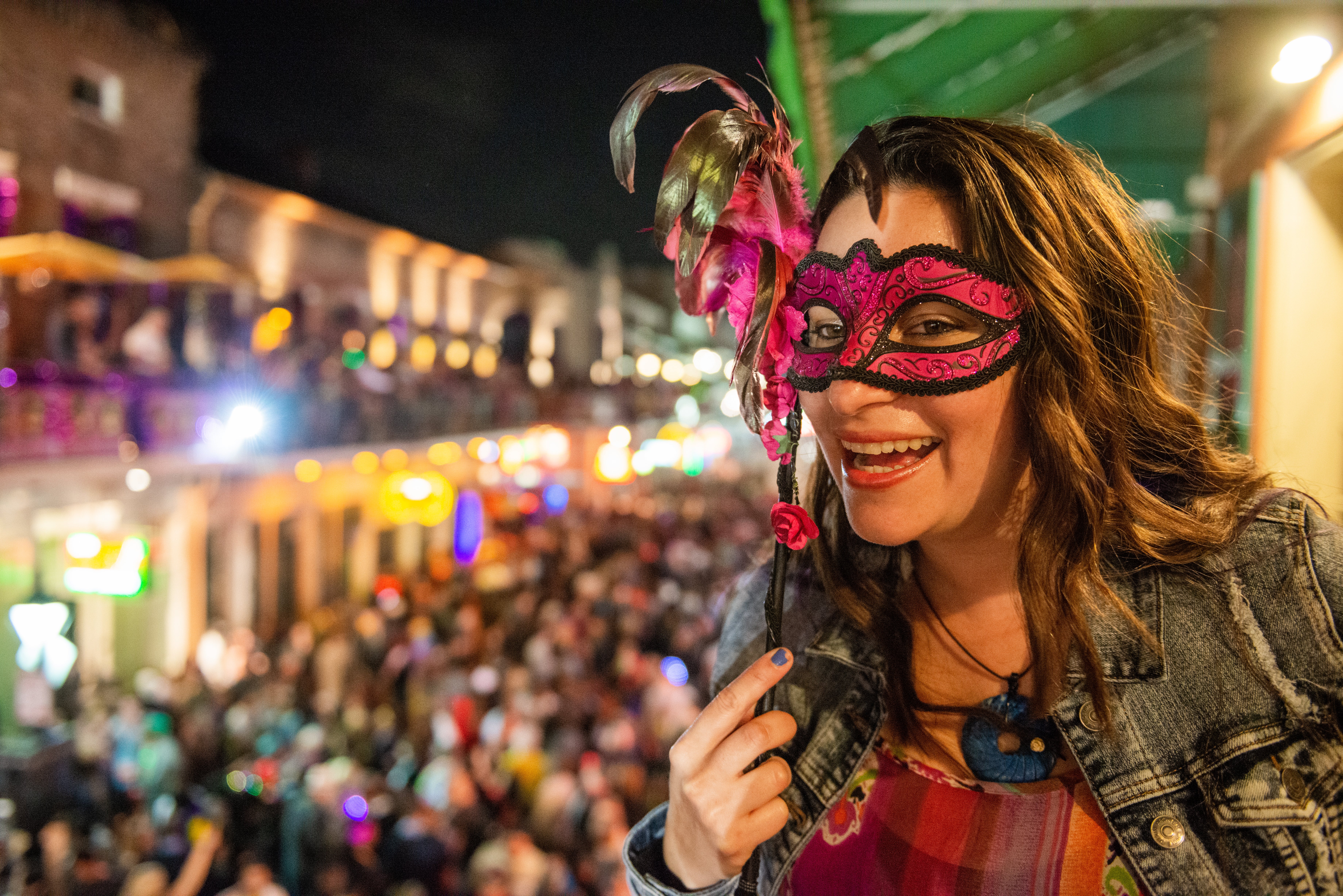 A woman enjoys the scene at Bourbon Street in New Orleans during Mardi Gras. (Getty Images)