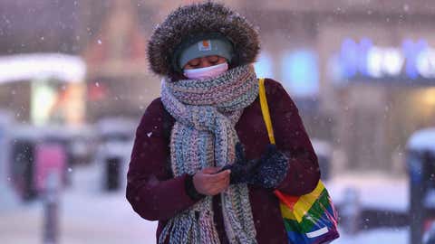 A woman walks through the snow in Times Square during a winter storm on Feb. 1, 2021, in New York City. A powerful winter storm is set to dump feet of snow along a stretch of the U.S. East Coast including New York City on Feb. 1, 2021, after blanketing the nation's capital. The National Weather Service issued storm warnings from Virginia to Maine, a swathe home to tens of millions of people, and forecast snowfall of 18 to 24 inches in southern New York, northeastern New Jersey and parts of southwest Connecticut. (Angela Weiss/AFP via Getty Images)