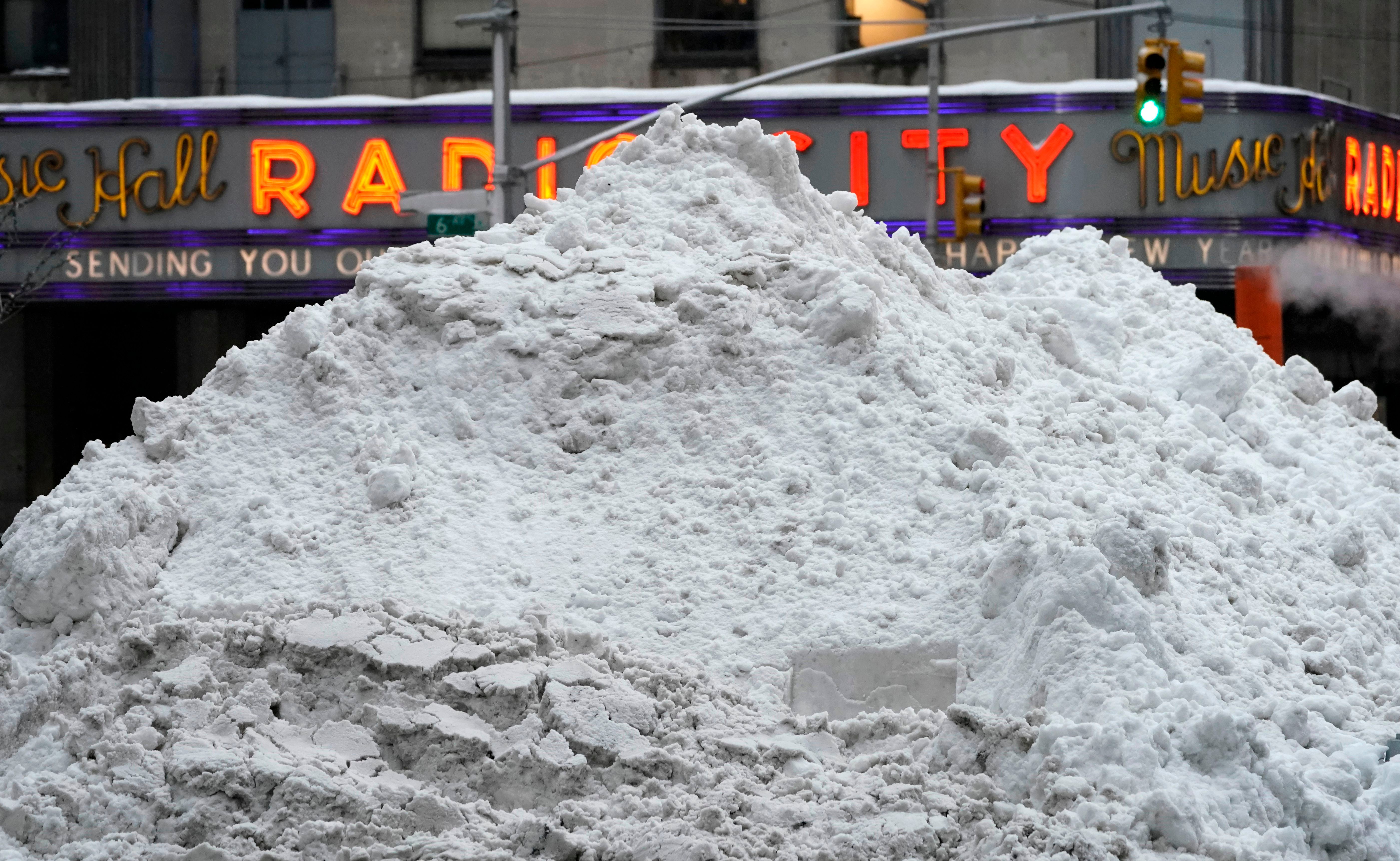 A mound of snow is seen outside Radio City Music Hall in New York on Feb. 2, 2021. A huge snowstorm has brought chaos to the United States' east coast, shuttering airports, closing schools and forcing the postponement of coronavirus vaccinations into Tuesday morning as New York City steeled itself for possibly one of its heaviest ever snowfalls. New York declared a state of emergency restricting non-essential travel, moved all children back to remote learning and rescheduled long-awaited vaccine shots as some parts of the city were hit by more than 18 inches (1.5 feet) of snow. CNN meteorologists said that figure could reach two feet before the storm comes to an end. (Timothy A. Clary/AFP via Getty Images)