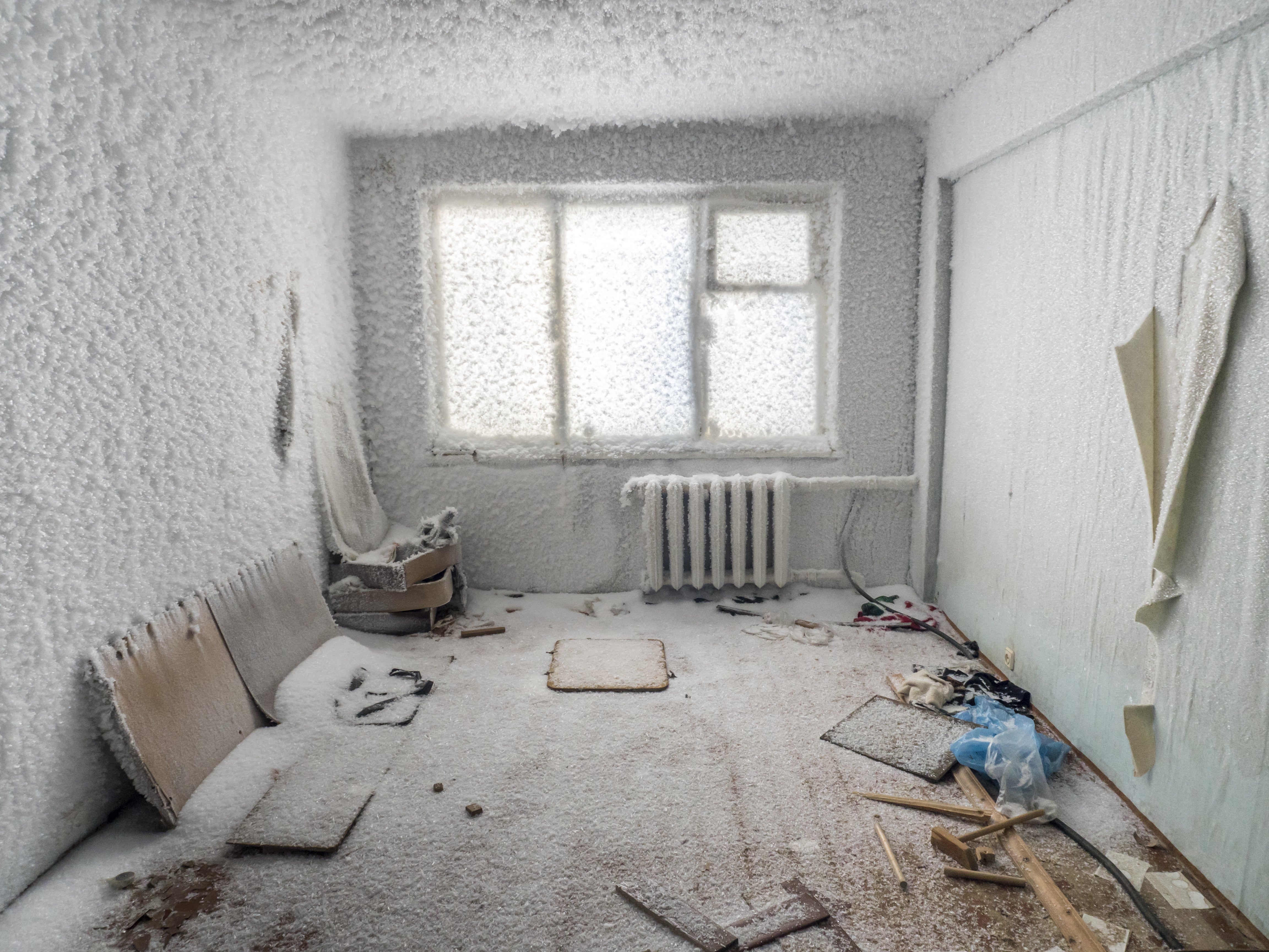 A photo shows the inside of a snow- and ice-covered abandoned building in Sementnozavodsky region, about 12 miles from the coal-mining town Vorkuta, Komi Republic, Russia on March 1, 2021. (Maria Passer/Anadolu Agency via Getty Images)