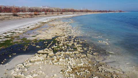 A general view of underwater fairy chimneys, also known as stalagmites, after the withdrawal of water due to climate change and drought in Van Lake in Adilcevaz district of Bitlis, Turkey, on April 19, 2022. Stalagmites become visible due to withdrawal of water at different points of the coastline within the borders of the Adilcevaz district of Bitlis, which has the longest shore to Lake Van, and varying in length from three to 20 inches, draw attention. The stalagmites, which took thousands of years to form and are seen under water, attract attention from nature lovers and photography enthusiasts as well as scientists. (Sener Toktas/Anadolu Agency via Getty Images)