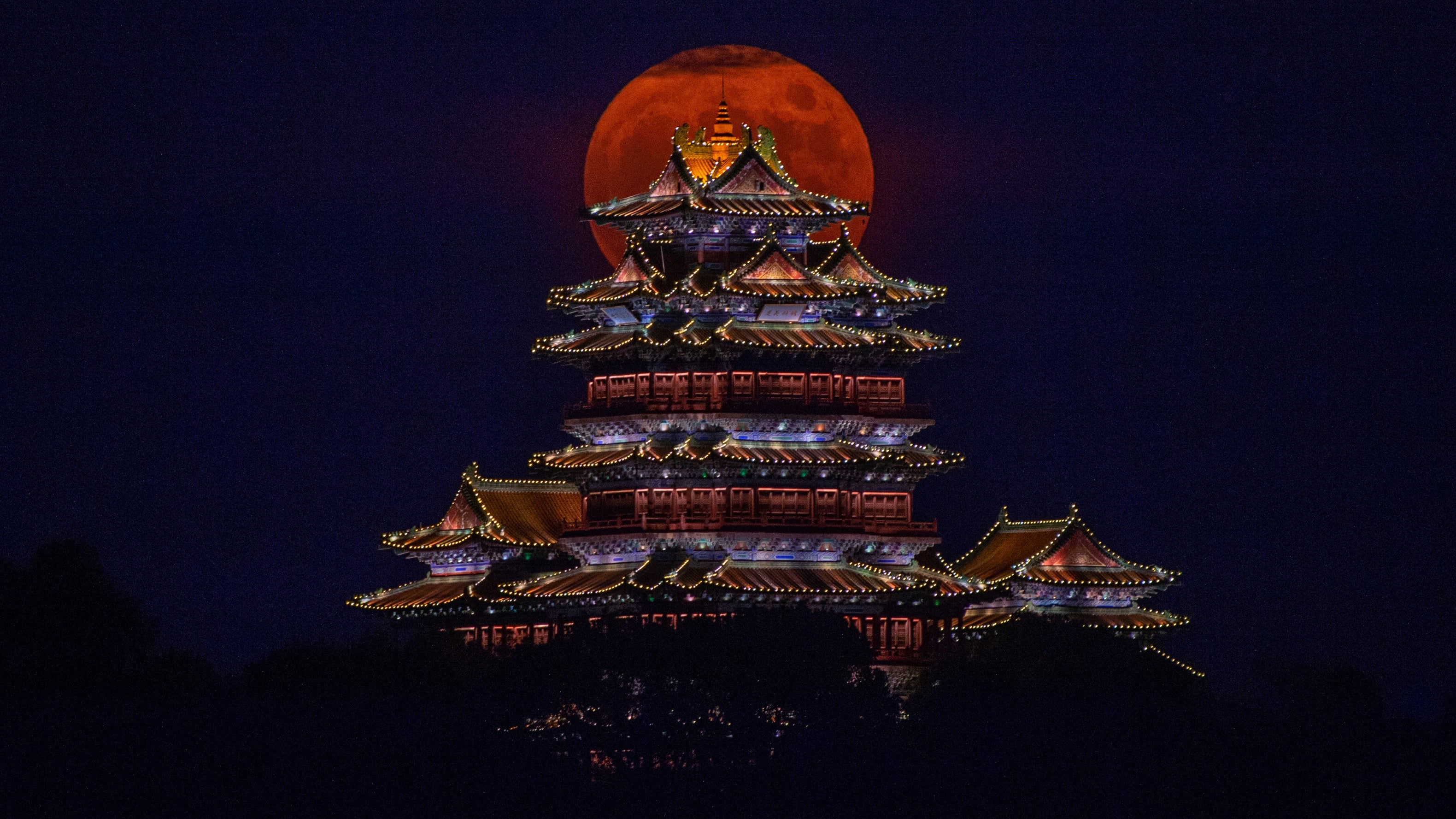 The full moon rises behind the Ming-style Yuejiang Tower in Nanjing in Jiangsu Province, China, Saturday, Sept. 10, 2022, the night of the traditional Moon Festival, on Saturday, Sept. 10, 2022. (Fang Dongxu/ Feature China/Future Publishing via Getty Images)