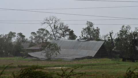 The fallen roof of a house is seen in Consolacion del Sur, Cuba, on Sept. 27, 2022, during the passage of Hurricane Ian. - Hurricane Ian made landfall in western Cuba early Tuesday, with the storm prompting mass evacuations and fears it will bring widespread destruction as it heads for Florida. (Adalberto Roque/ AFP via Getty Images)