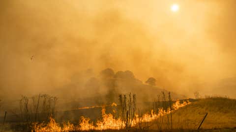 Flames and smoke from wildfires cover the landscape in California, U.S. Photographer: Philip Pacheco/Bloomberg