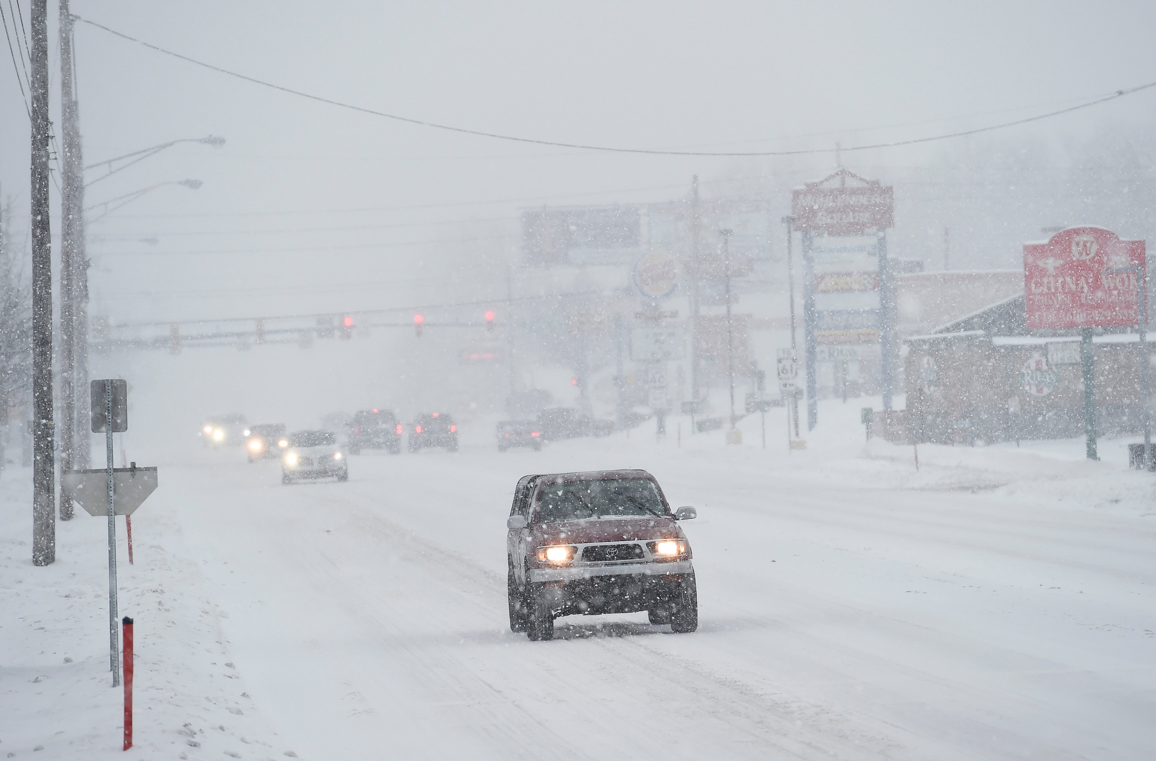 Cars drive on a snow covered 5th Street Highway on Monday, Feb. 1, 2021, in Muhlenberg Township, Pa., during a nor'easter that hit the East Coast with heavy snow and winter weather. (Ben Hasty/MediaNews Group/Reading Eagle via Getty Images)