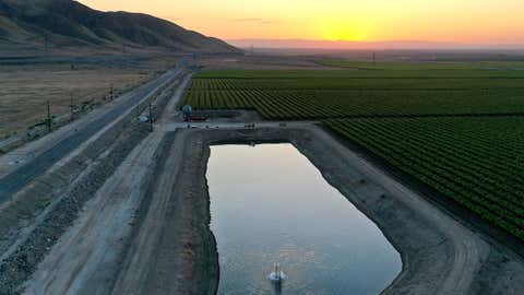 An aerial view as the sun sets beyond agricultural fields on April 21, 2021, near Bakersfield, Calif. California Gov. Gavin Newsom today declared a drought emergency in two counties following a winter with little precipitation. The order will allow the state to more quickly prepare for anticipated water shortages. (Mario Tama/Getty Images)