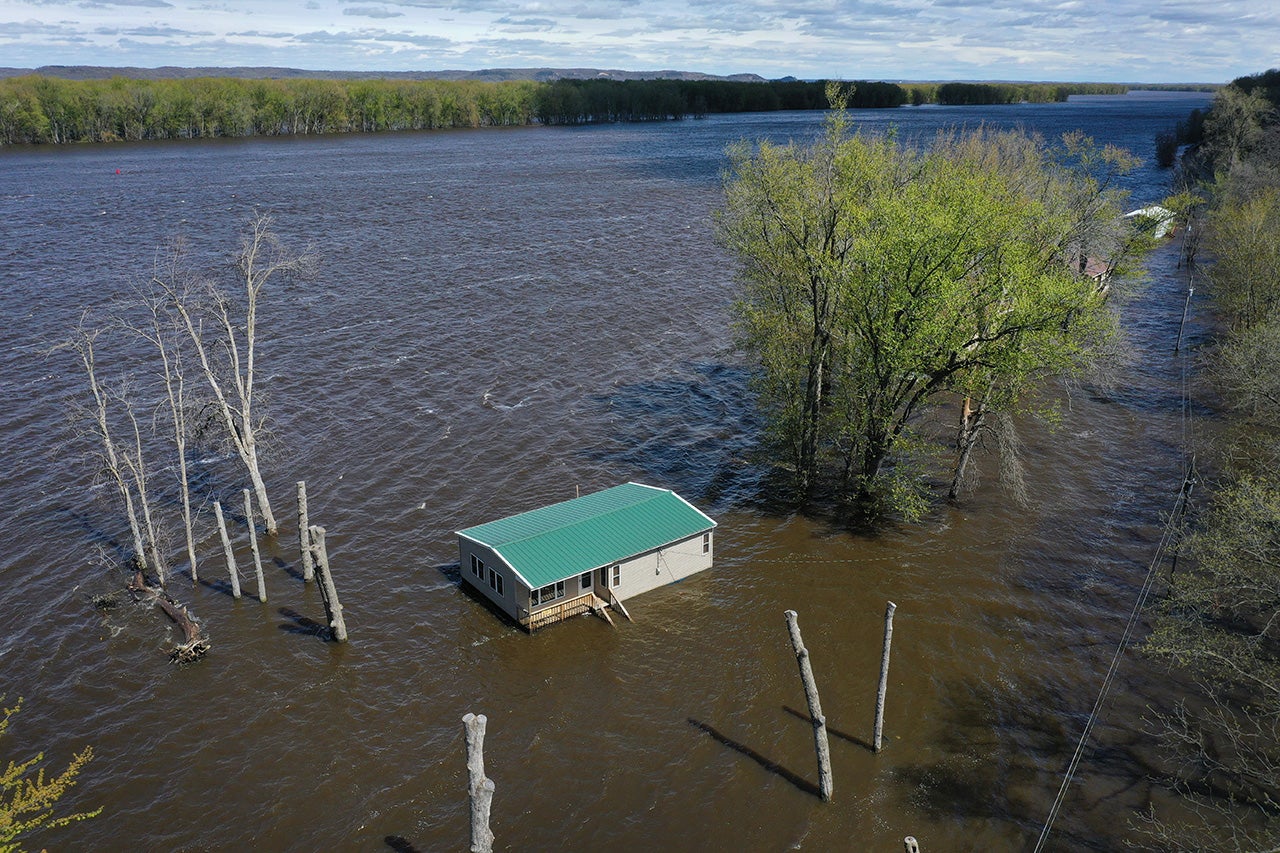 Floodwaters surround a home along the Mississippi River on May 1, 2023, near Bellevue, Iowa. Although the Mississippi River crested in the area on Saturday, according to the National Weather Service, the River at Bellevue is not expected to drop below major flood stage until next weekend. (Scott Olson/Getty Images)