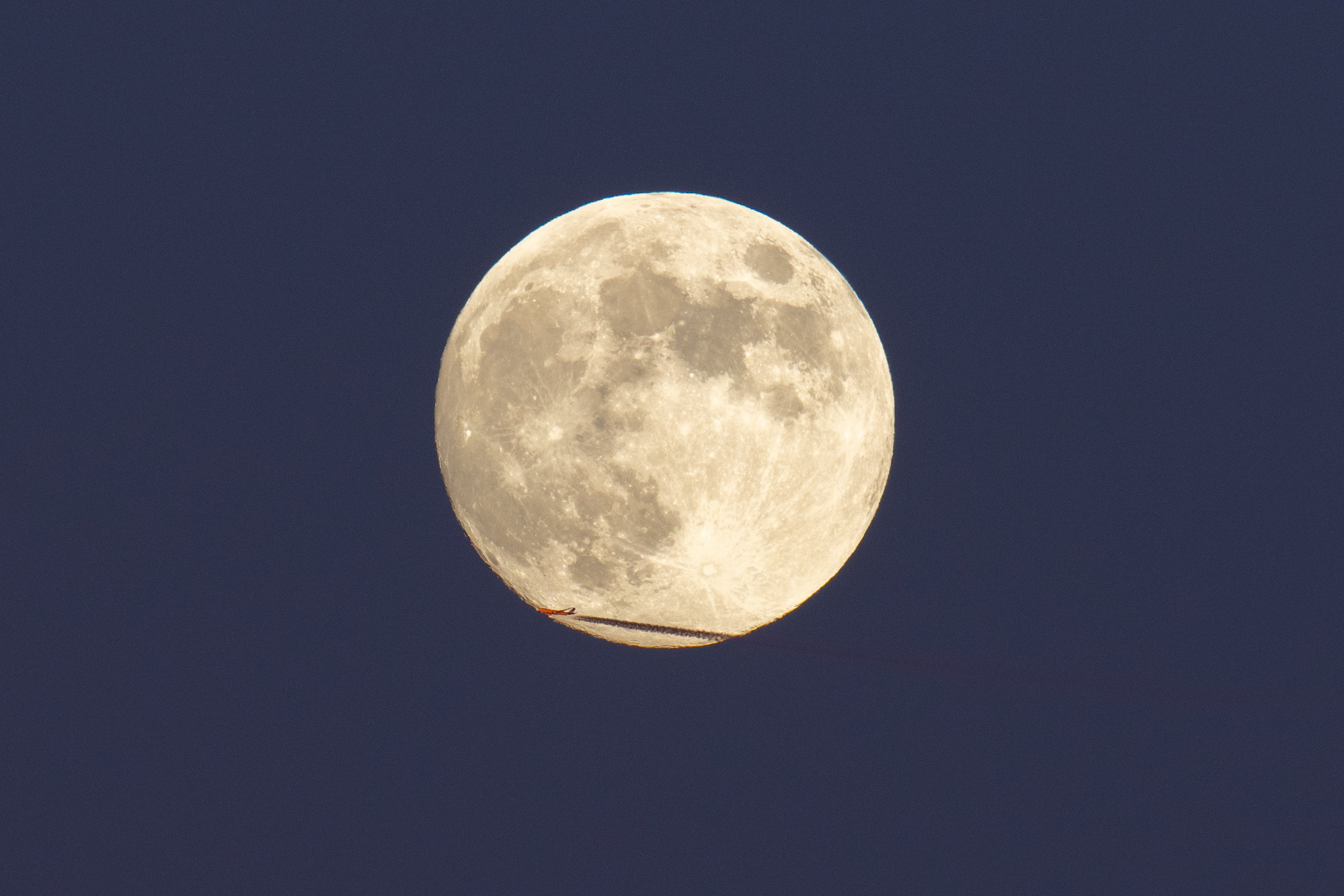 An aircraft crossing beaver full moon is seen from L'Aquila, Italy, on November 26th, 2023. November Full Moon is known among Native Americans as the 'Beaver Moon'  because, during this month, beavers prepare to face the harshness of winter by building their famous dams and stockpiling food in their burrows. (Photo by Lorenzo Di Cola/NurPhoto via Getty Images)