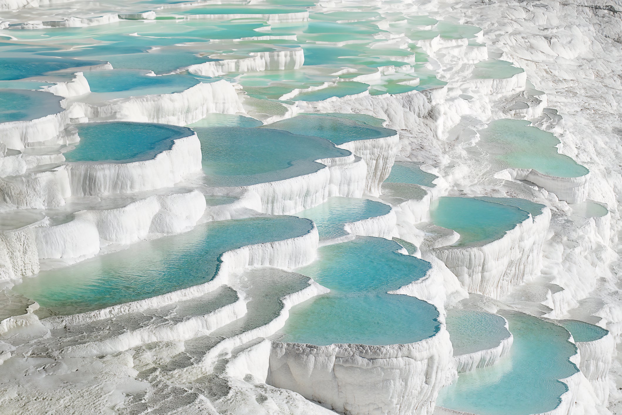 Pamukkale is a natural site in Denizli Province in southwestern Turkey. The area is famous for a carbonate mineral left by the flowing of thermal spring water.