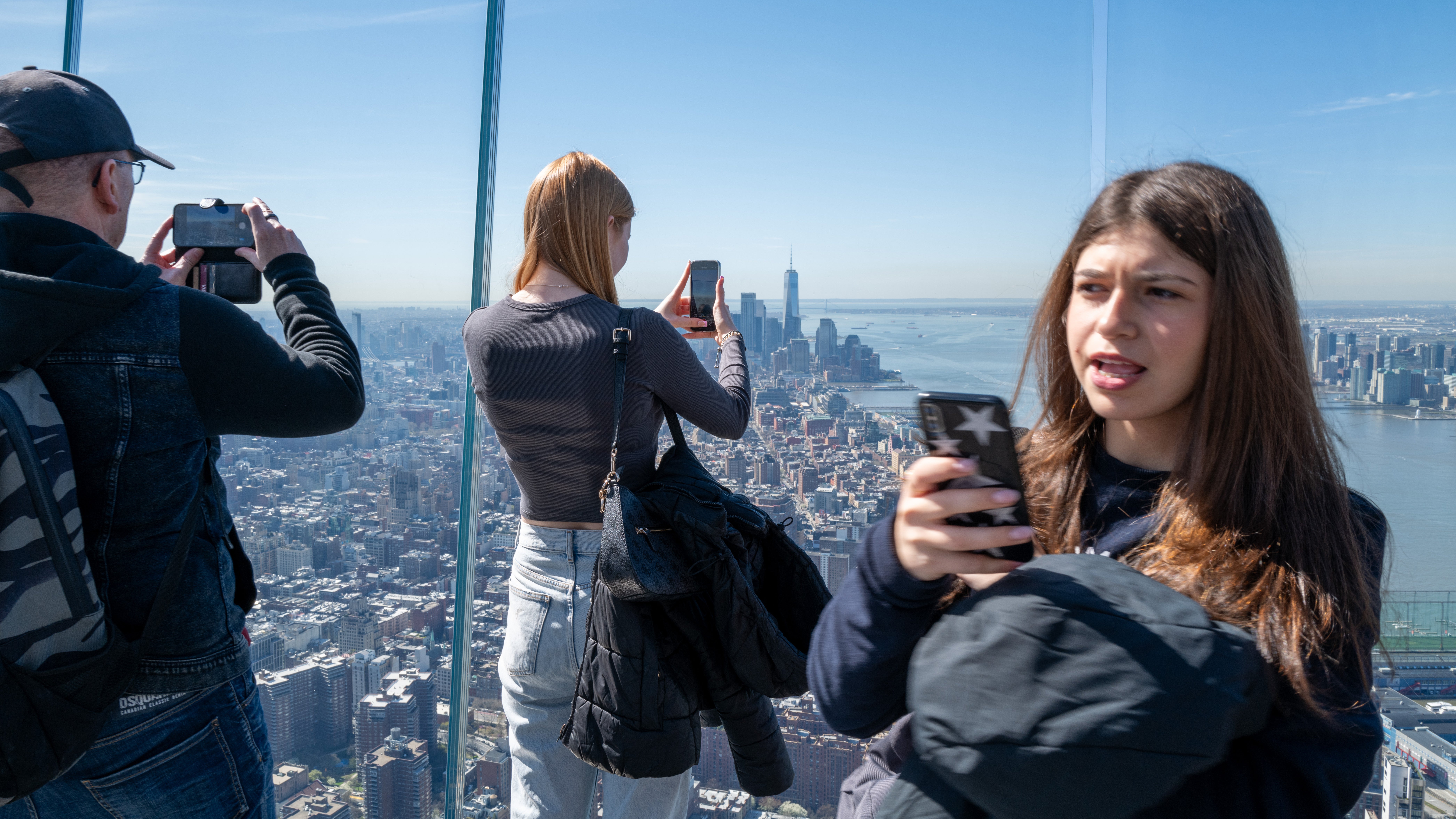 NEW YORK, NEW YORK - APRIL 08: People gather on the observation deck of Edge at Hudson Yards before a partial solar eclipse on April 08, 2024 in New York City. While New York City isn't in the path of totality, it will see up to 90% of the sun covered by the moon. Around New York and in the path of totality, millions of residents and tourists are preparing for a total solar eclipse. (Photo by Spencer Platt/Getty Images)