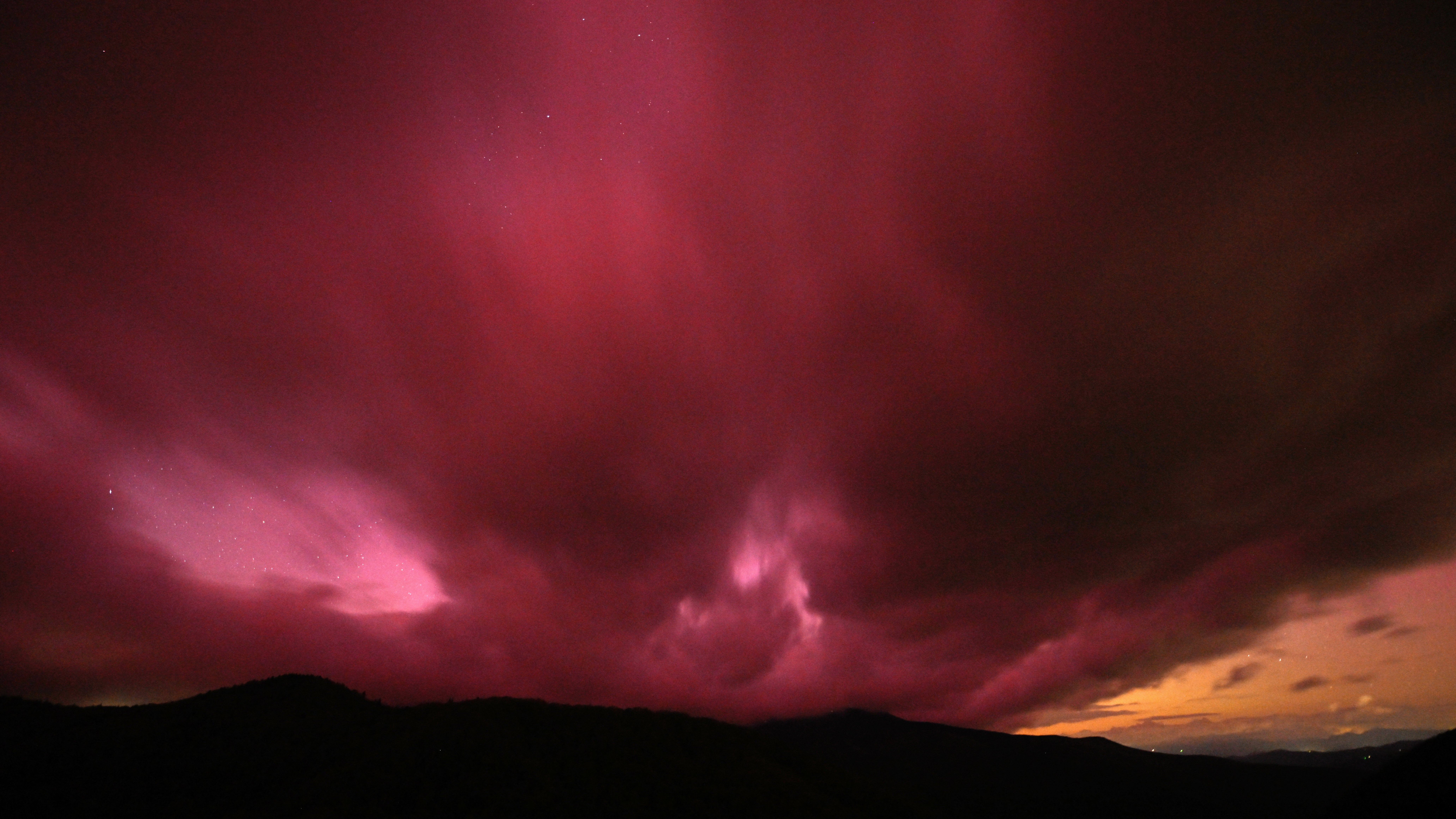 MOUNT MITCHELL, UNITED STATES - MAY 10: Unusual sun activity created a G5 Geostorm on Earth sparks northern lights (Aurora Borealis) in Mount Mitchell, North Carolina, United States on May 10, 2024. (Photo by Peter Zay/Anadolu via Getty Images)