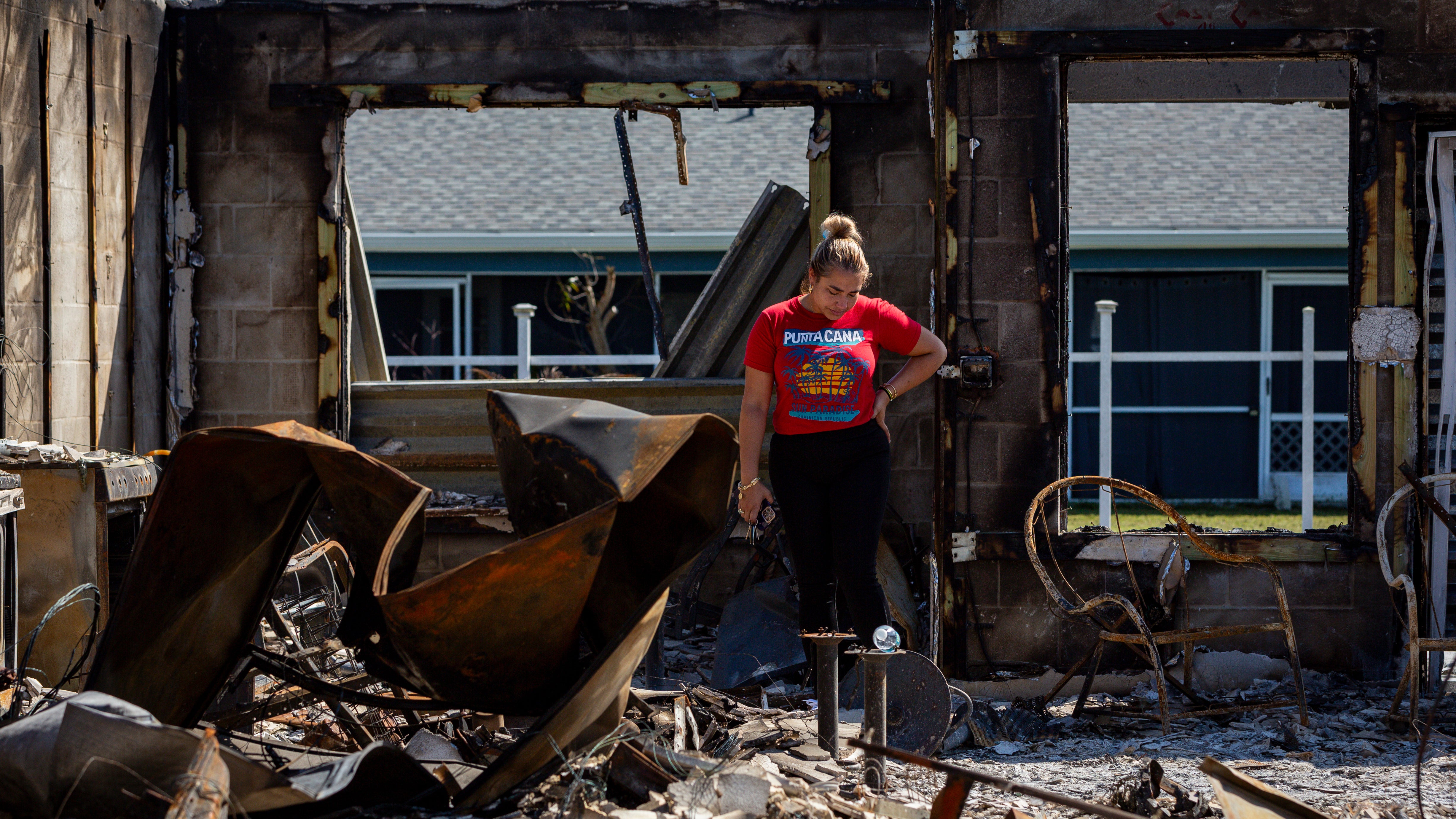 Elena Gonzalez, 37, looks at their burned-out home after Hurricane Milton's landfall on Oct. 14, 2024, in Fort Myers, Florida. (Eva Marie Uzcategui for The Washington Post via Getty Images)