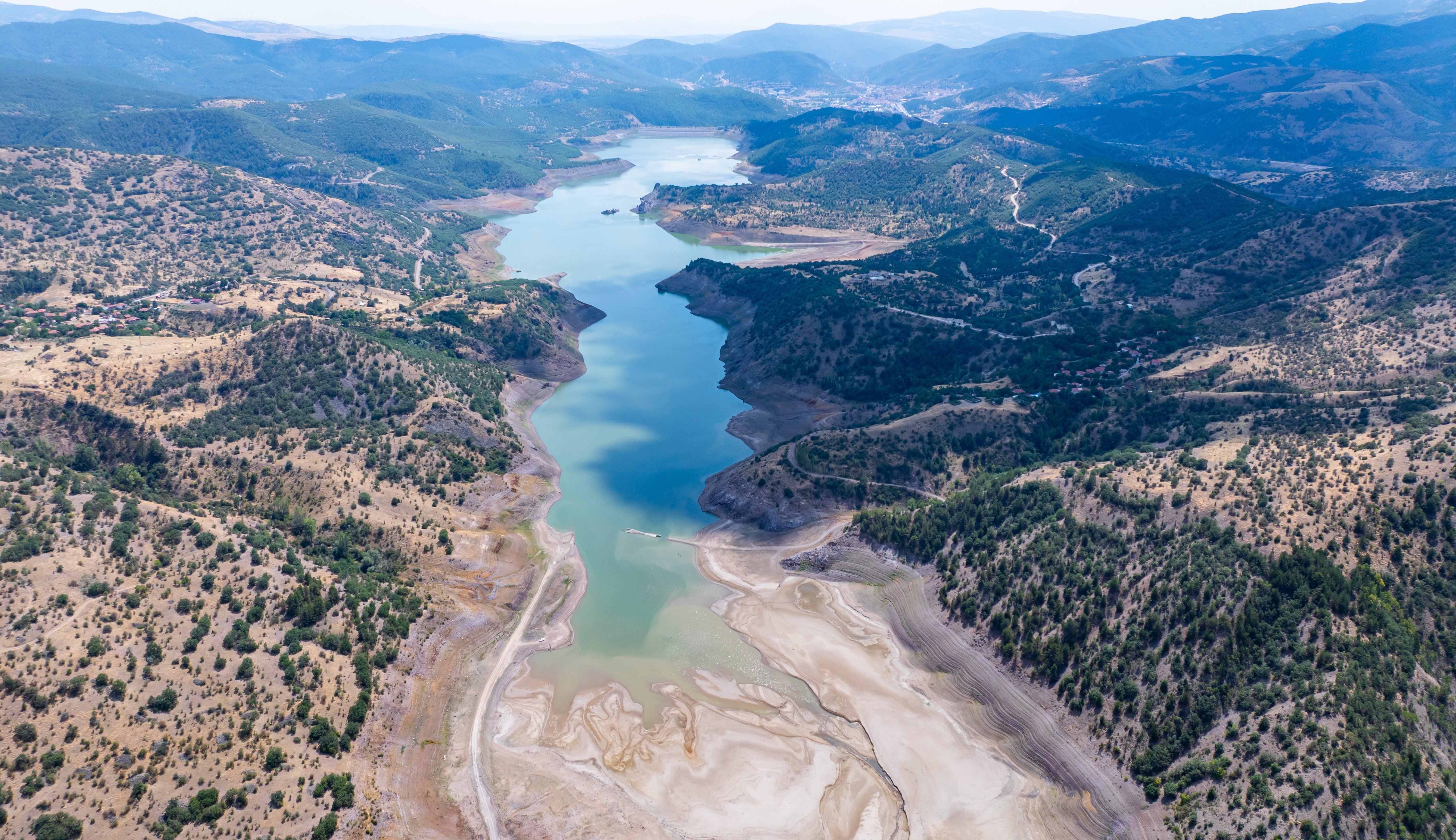 ANKARA, TURKIYE - AUGUST 19: An aerial view shows Egrekkaya Dam and its surrounding area as water has receded by approximately 40 to 50 meters in some areas at Egrekkaya, Camlidere, Kurtbogazi, and Akyar dams due to a dry summer season and insufficient rainfall, in Ankara, Turkiye, on August 19, 2025. The occupancy rate in Ankara's dams has dropped significantly compared to the same period last year  from 39.41% to 19.42%. (Photo by Muhammed Abdullah Kurtar/Anadolu via Getty Images)