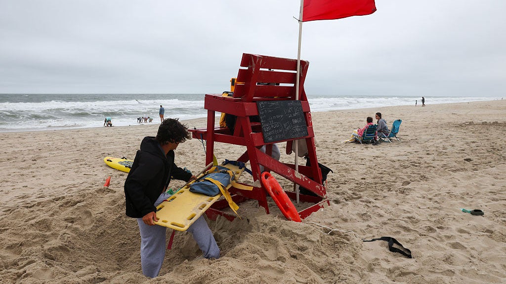 SURF CITY, NEW JERSEY- AUGUST 20: Lifeguards stand along a beach closed to swimmers due to strong riptides and high surf from Hurricane Erin on August 20, 2025, in Surf City, Long Beach Island, New Jersey. Hurricane Erin has been classified as a Category 2 hurricane with a current maximum sustained wind speed near 100 miles per hour. Erin is expected to bring high surf to the New Jersey and New York coastal communities, and multiple beaches throughout the area have been closed in anticipation of dangerous rip currents and rough waters. (Photo by Spencer Platt/Getty Images)