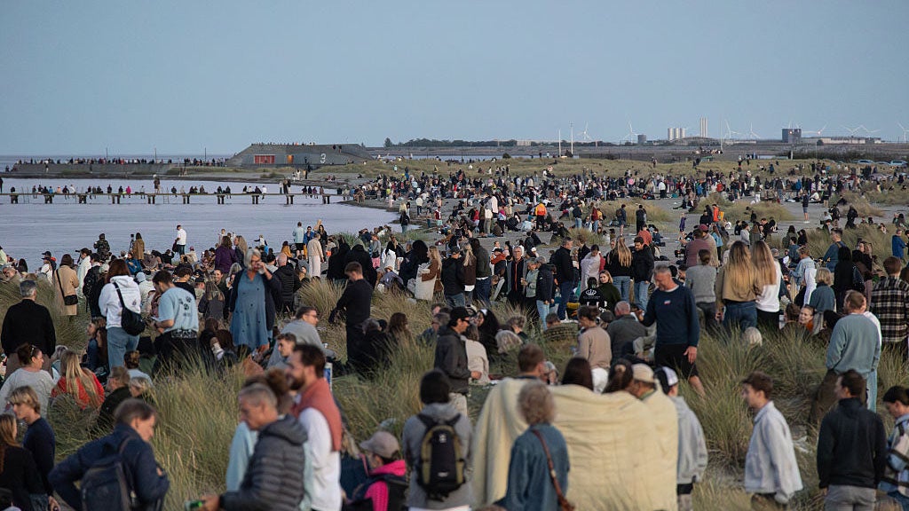 People gather to watch the ''Blood Moon'' rise over Amager Strandpark during a total lunar eclipse in Copenhagen, Denmark, on September 7, 2025. (Photo by Kristian Tuxen Ladegaard Berg/NurPhoto via Getty Images)