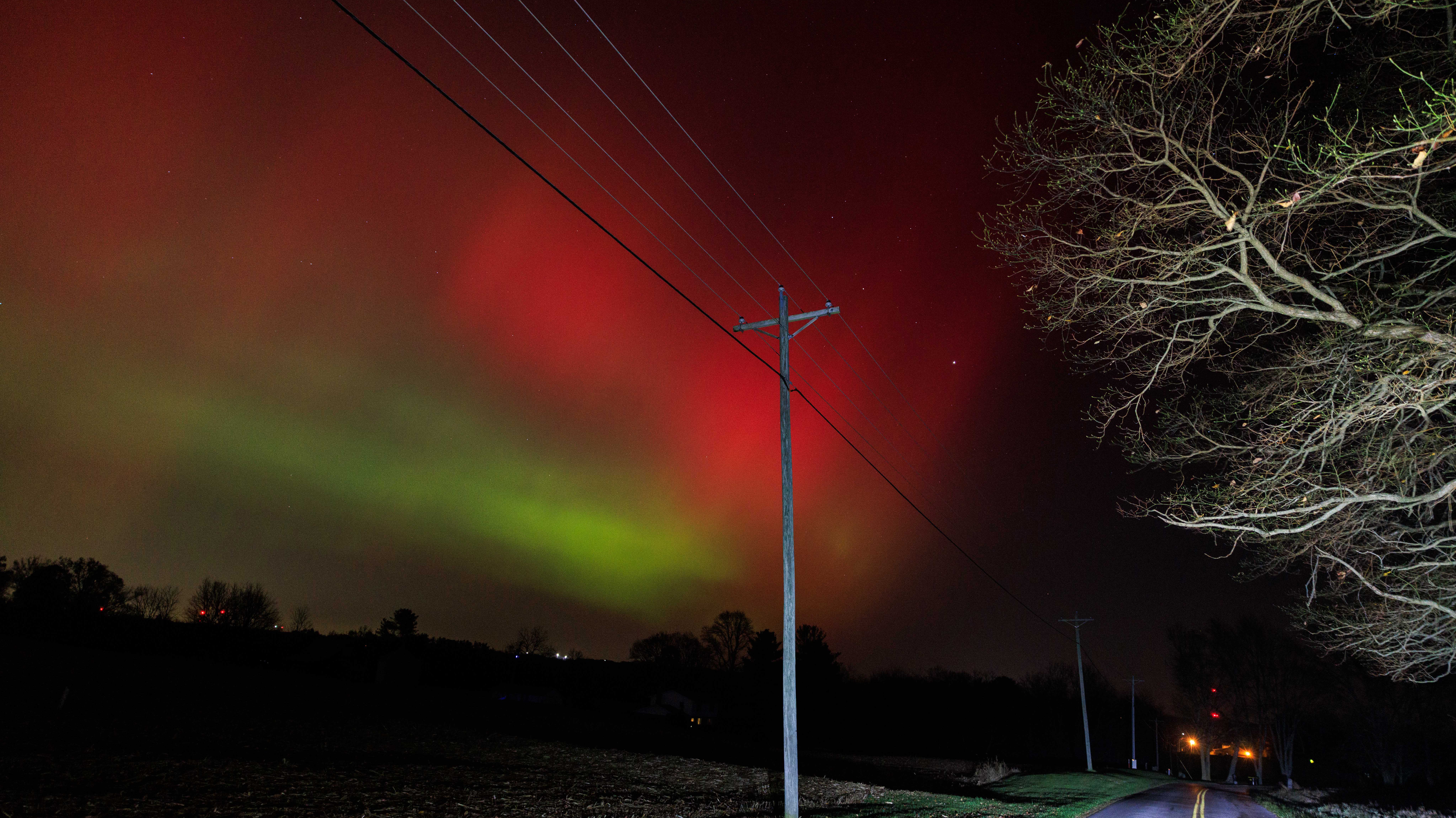 BLOOMINGTON, INDIANA - NOVEMBER 12: The aurora borealis glows above along Maple Grove Road in rural Monroe County as a strong geomagnetic storm from recent solar activity pushes the Northern Lights unusually far south on November 12, 2025, in Bloomington, Indiana. Displays were reported across the United States as far south as Texas, Alabama, Georgia, and north Florida. (Photo by Jeremy Hogan/Getty Images)