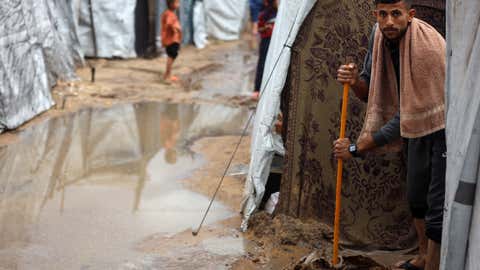 Weather Of The World: November 24 - 30 10 Palestinian men create channels in the sand to direct rain at a makeshift camp for displaced Palestinians in Gaza City, Palestine, November 25, 2025. (Photo by Majdi Fathi/Nurfoto via Getty Images)
