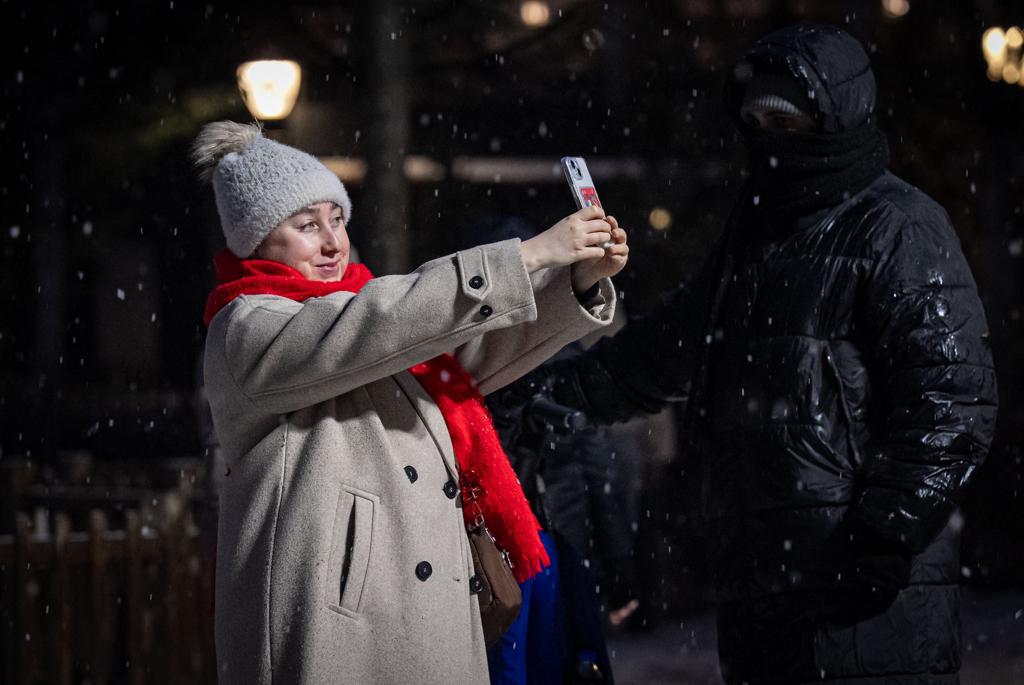 ANKARA, TURKIYE - JANUARY 22: A woman takes selfies at Kugulu Park, one of the city&acirc;s iconic parks, as snow, falling at intervals throughout the day, covers the streets and avenues in white by the evening in Ankara, Turkiye, on January 22, 2026. (Photo by Betul Abali/Anadolu via Getty Images)