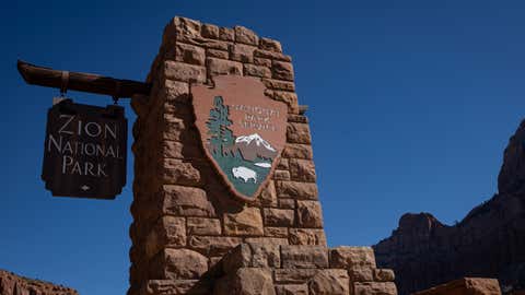 A detail view of the National Park Service and Zion National Park signs outside the entrance of the park in Springdale, Utah, on March 7, 2026. (Photo by Michael Yanow/NurPhoto via Getty Images)