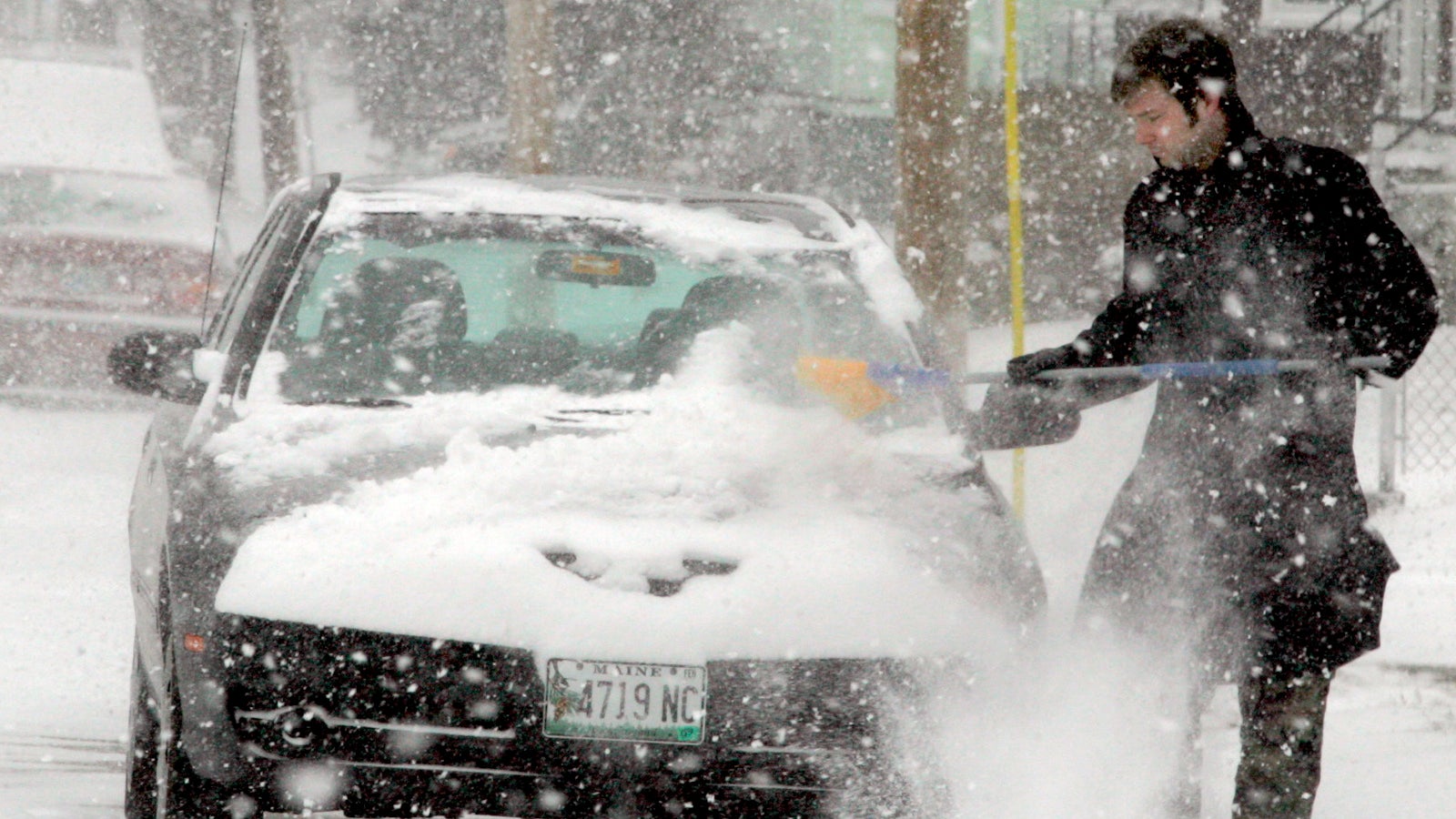Staff Photo by Herb Swanson, Sunday, February 12, 2006: Geoff Pritchard cleans light fluffy snow off his car parked on William Street in Portland on Sunday.  (Photo by Herb Swanson/Portland Press Herald via Getty Images)