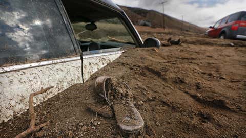 ELIZABETH LAKE ,CA., OCTOBER 16, 2015: A sandal is left behind  where a Mini Cooper is buried up to the windows in a mudslide on Elizabeth Lake Road October 16, 2015. One driver said there was a little bit of water on the road, then a wall of mud surrounded them (Mark Boster / Los Angeles Times ).