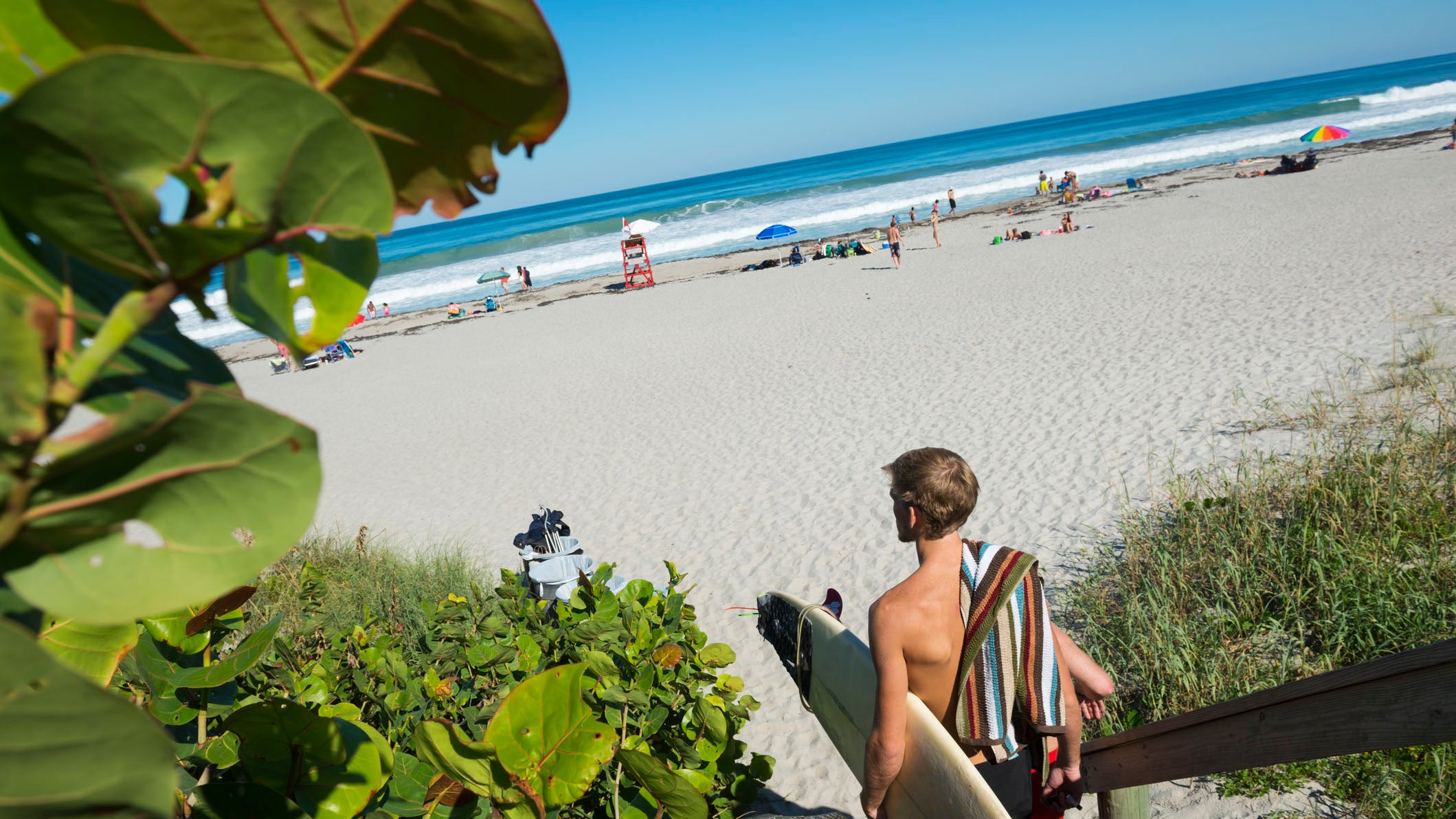 Indialantic, Florida, USA - October 18, 2014: A surfer arrives at the beach in search of swells left behind by Hurricane Gonzalo in Indialantic, Florida